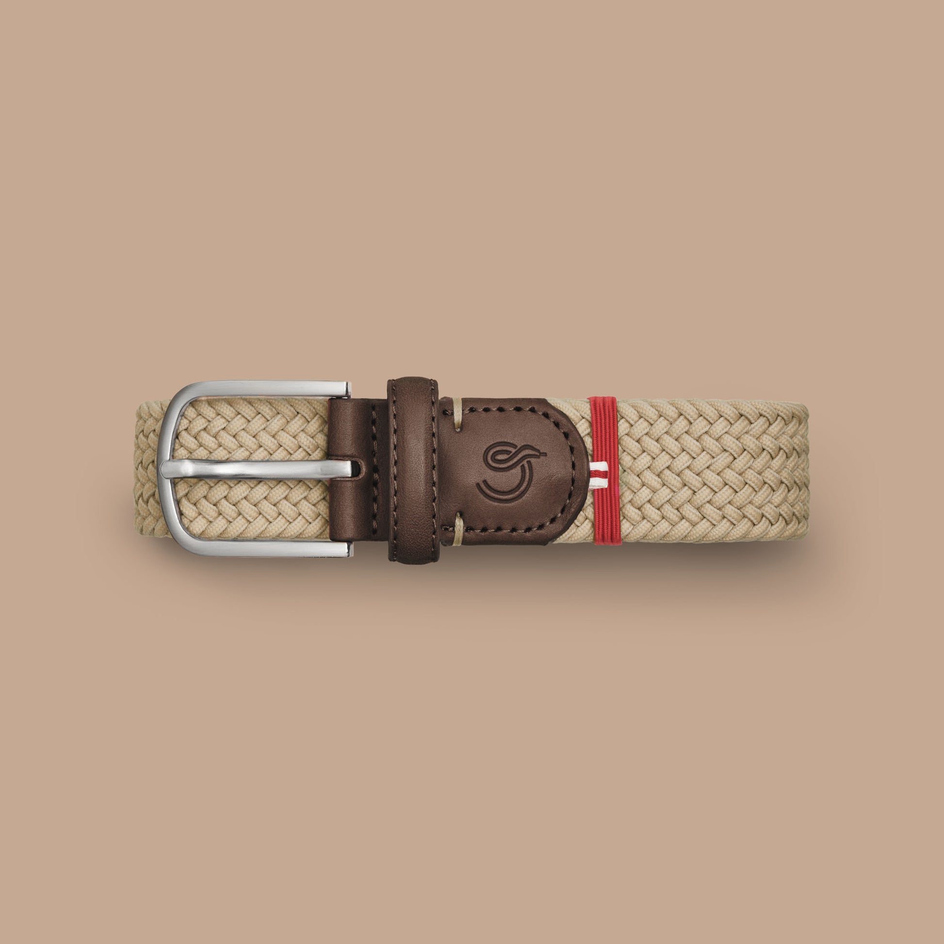 La Boucle mono dubai woven belt folded on beige background