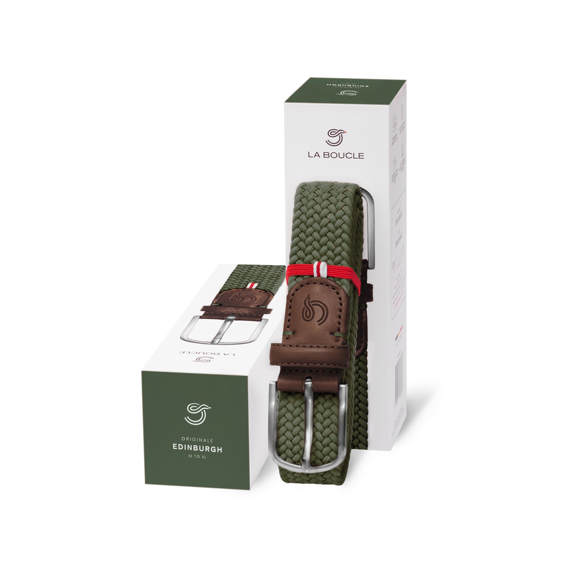 La Boucle mono edinburgh woven belt folded and leaning on a box next to a box on white background