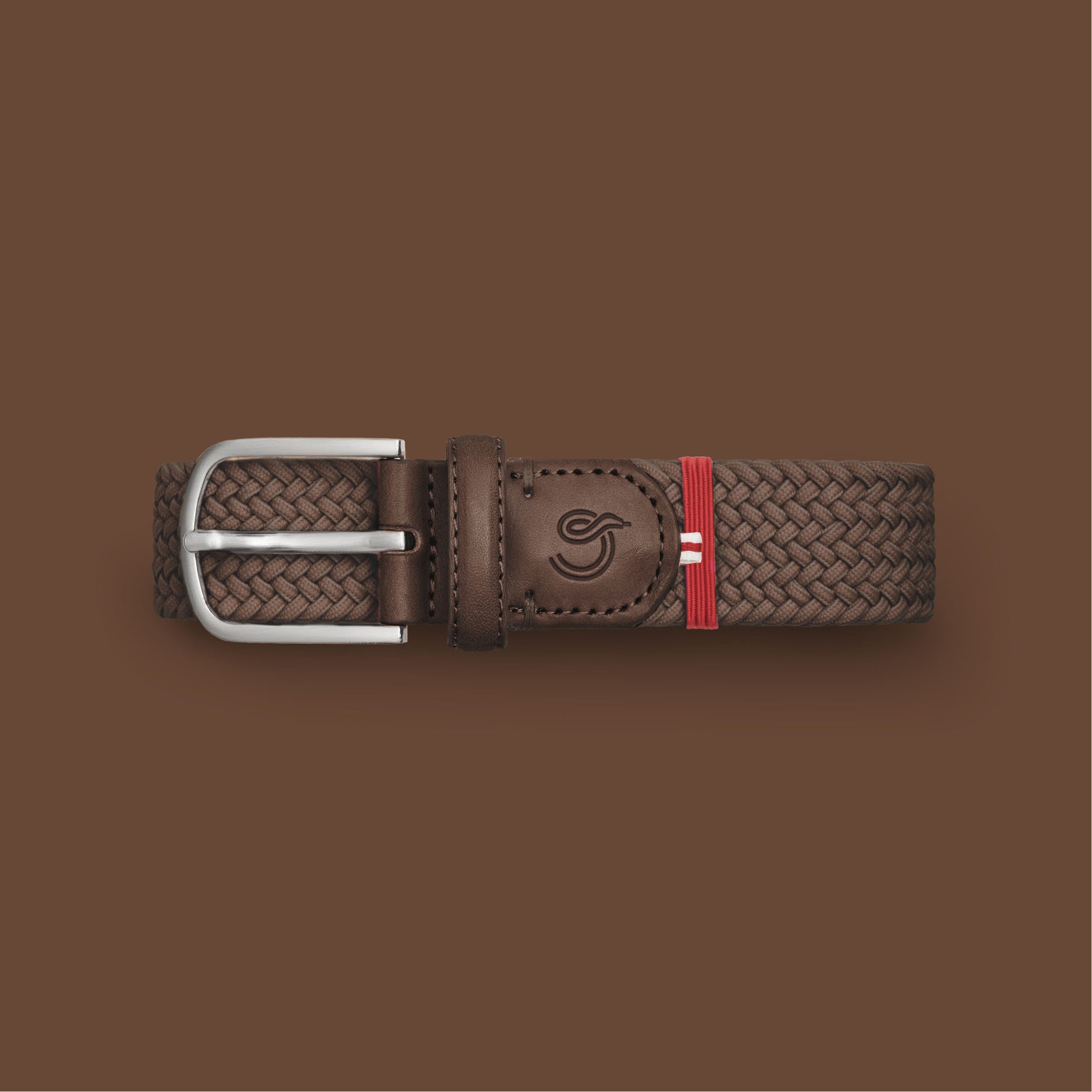 La Boucle mono edinburgh woven belt folded on brown background