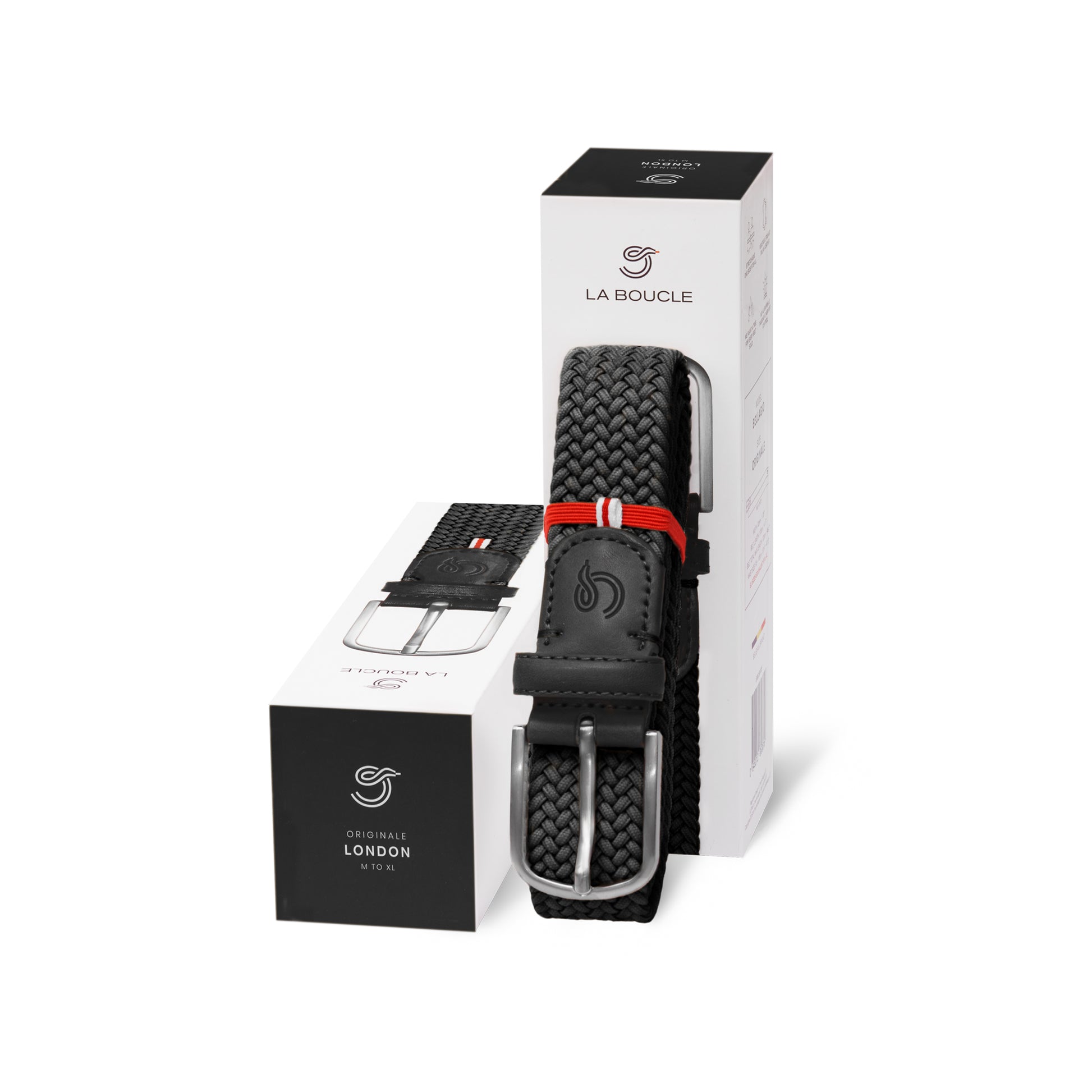 La Boucle mono London woven belt folded and leaning on a box next to a box on white background