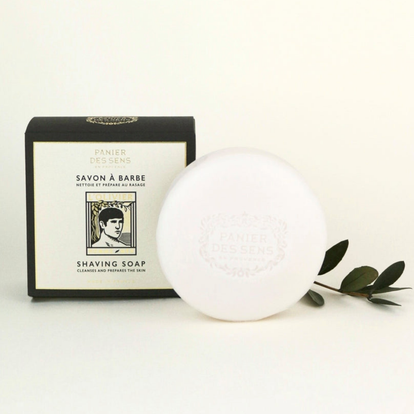 Panier Des Sens LOliver Shaving Soap 150g styled with packaging and leaves 