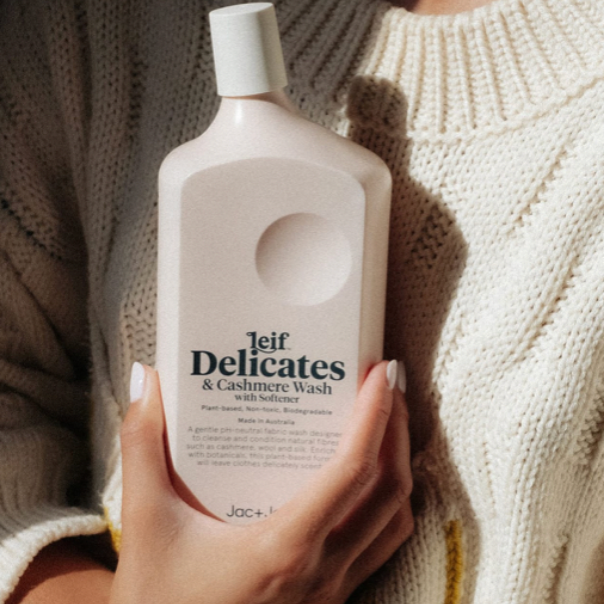Woman in woolen jumper holding Leif laundry wash 750ml Delicates & Cashmere