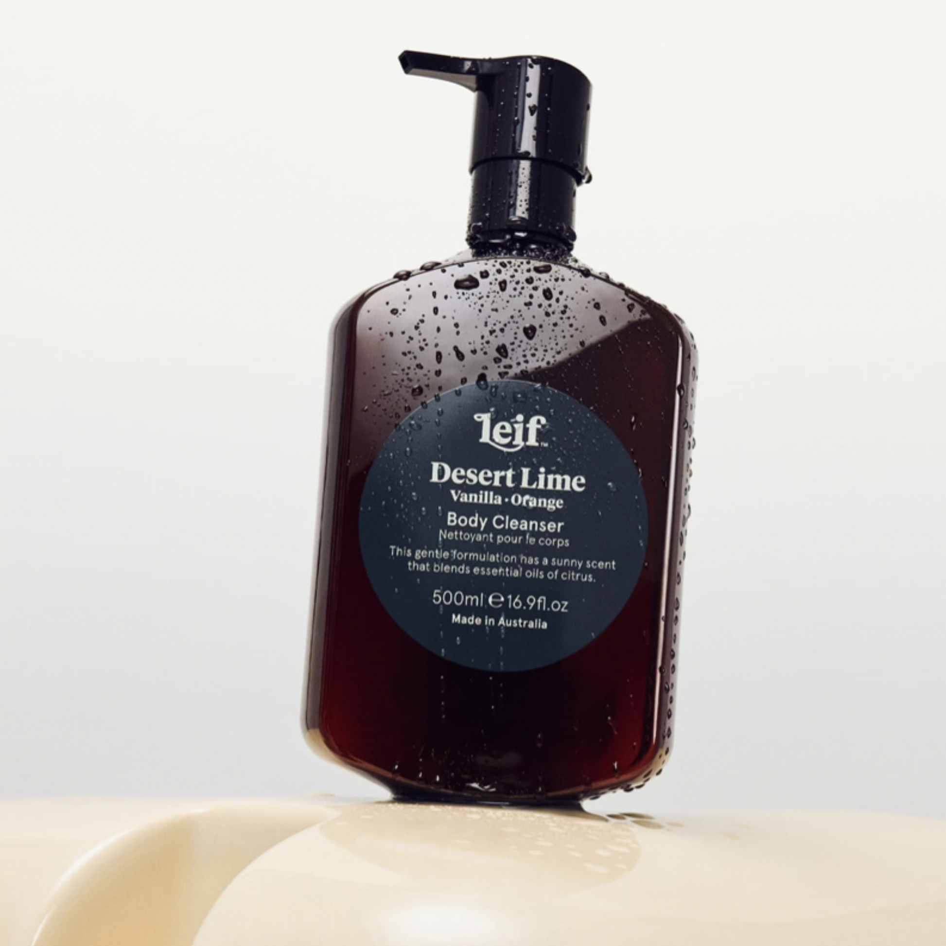 Leif body cleanser Desert Lime 500ml with water droplets on beige surface.