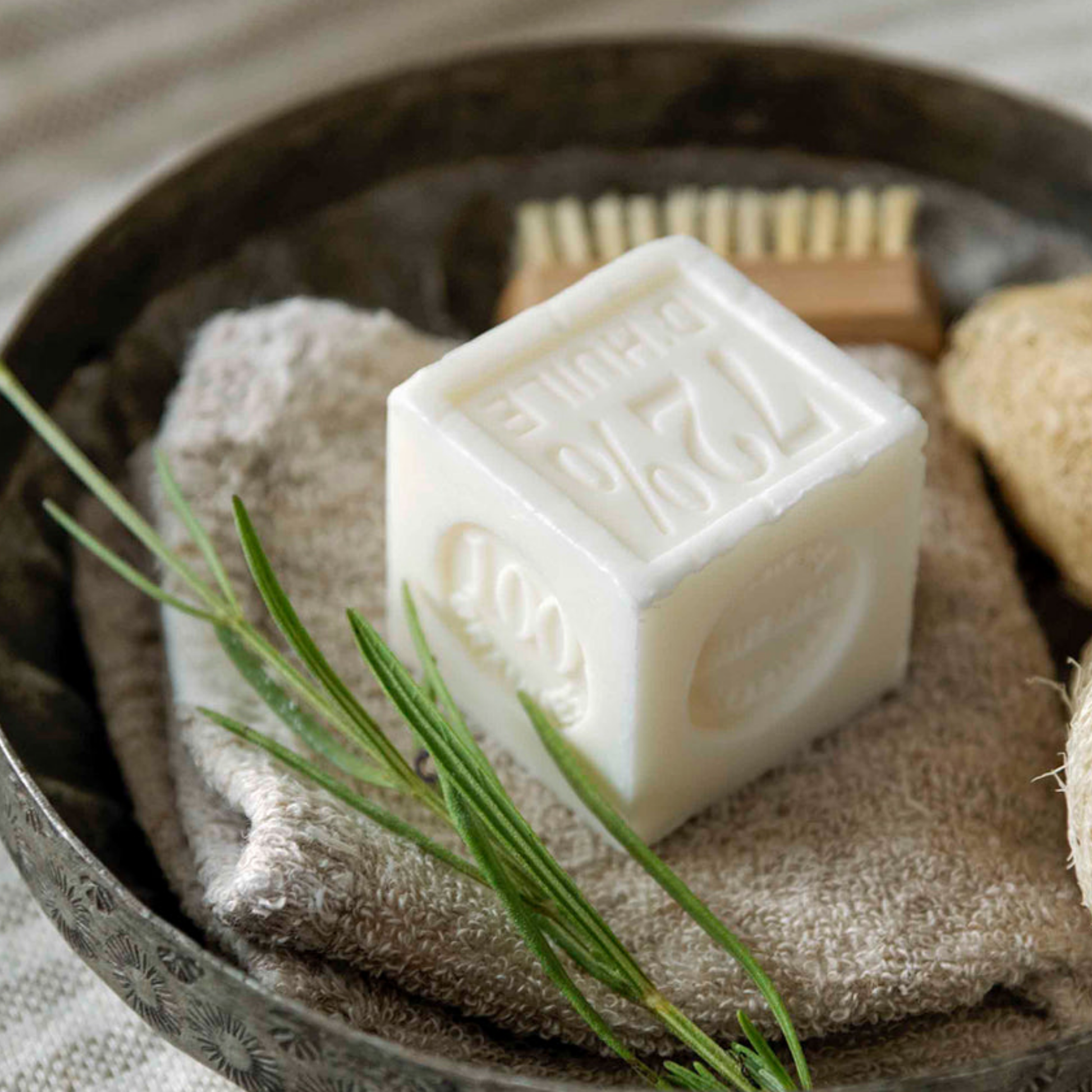 Les Choses Simple Marseille Soap 300g Olive Coco out of packaging on diaplay in bathroom with rosemary and towels