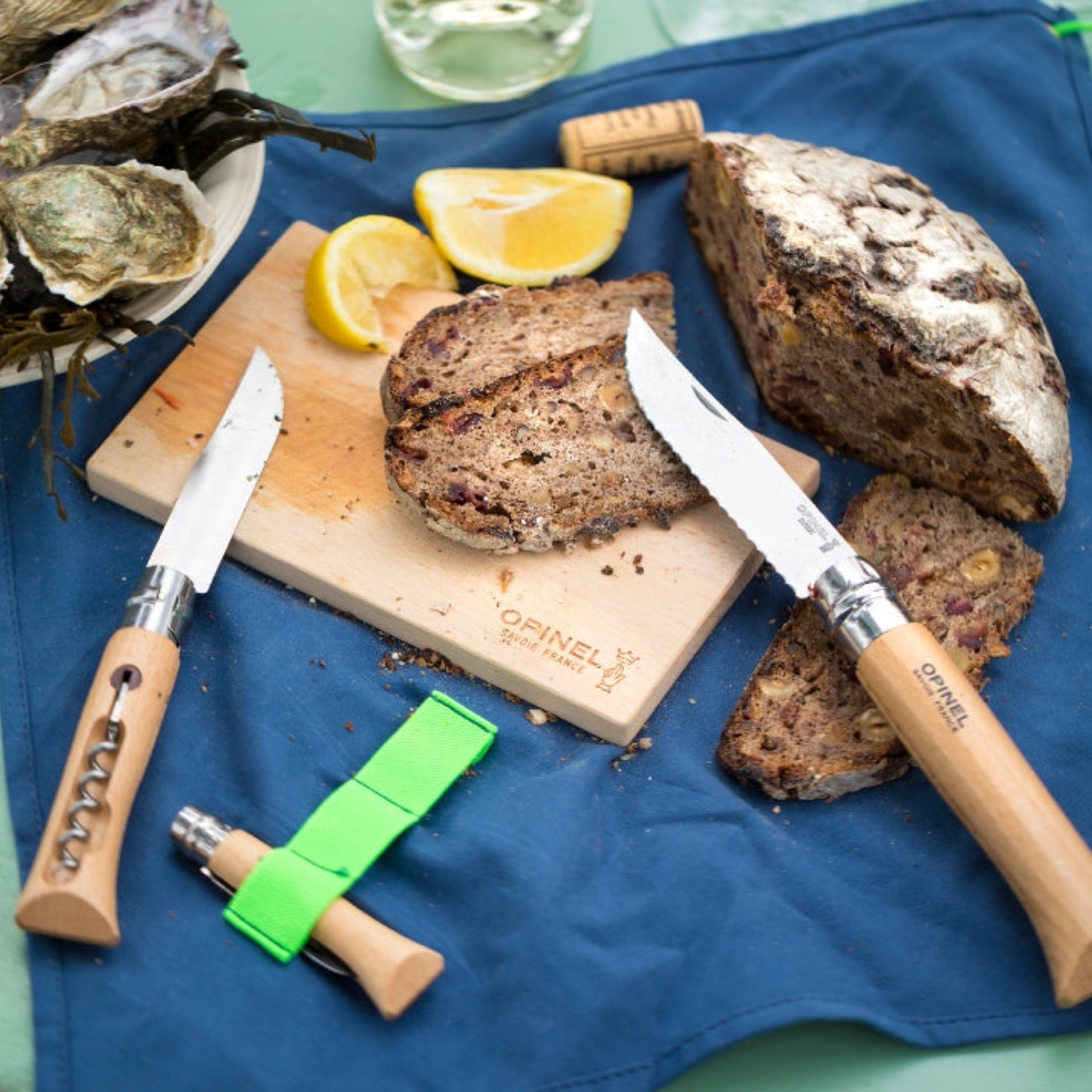 Opinel Nomad 3 Piece Cooking Kit Gift Box in use on picnic with oysters, lemon and bread on chopping board