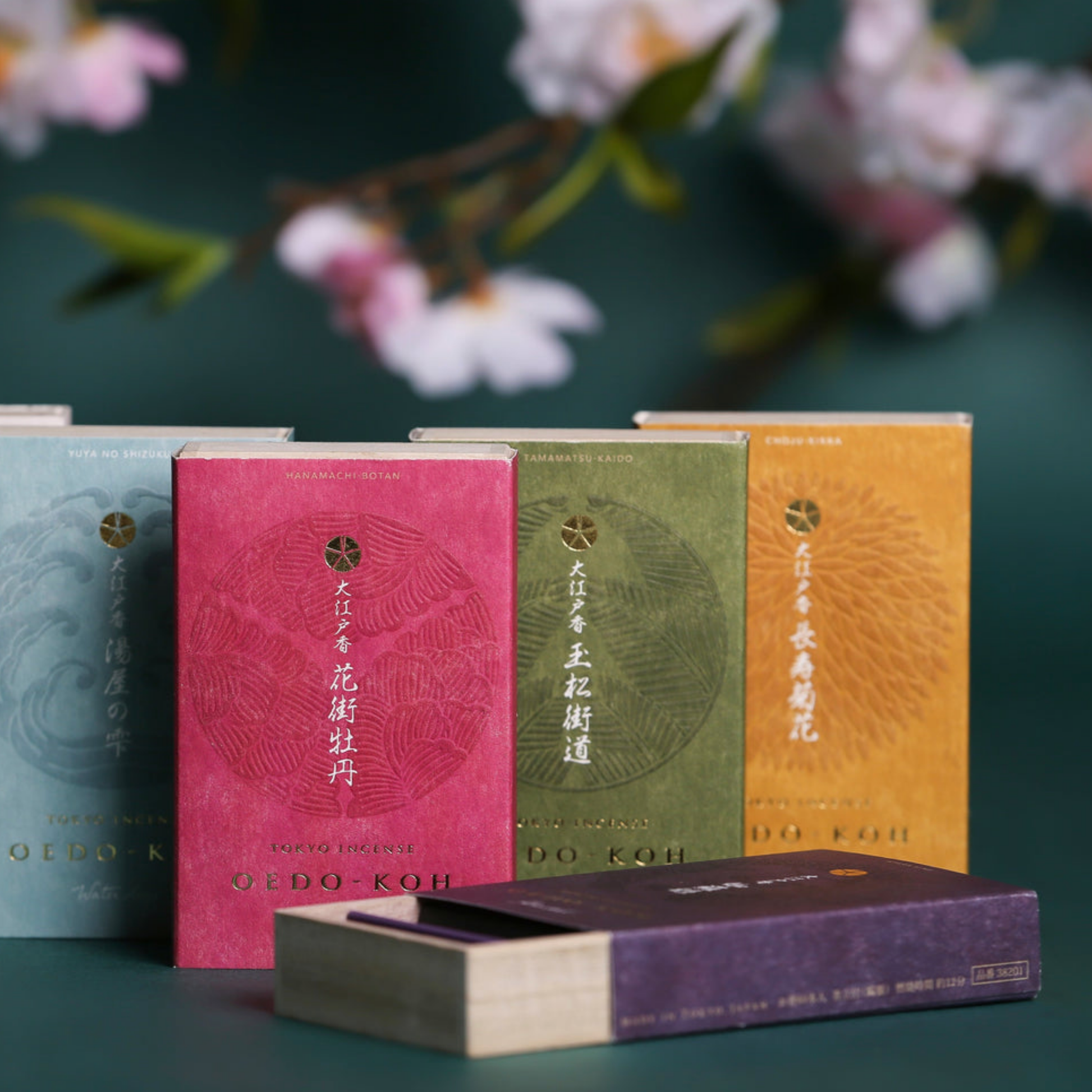 Assorted Oedo-Koh Incense infront of flowers with Oedo-Koh Incense Aloeswood half opened 