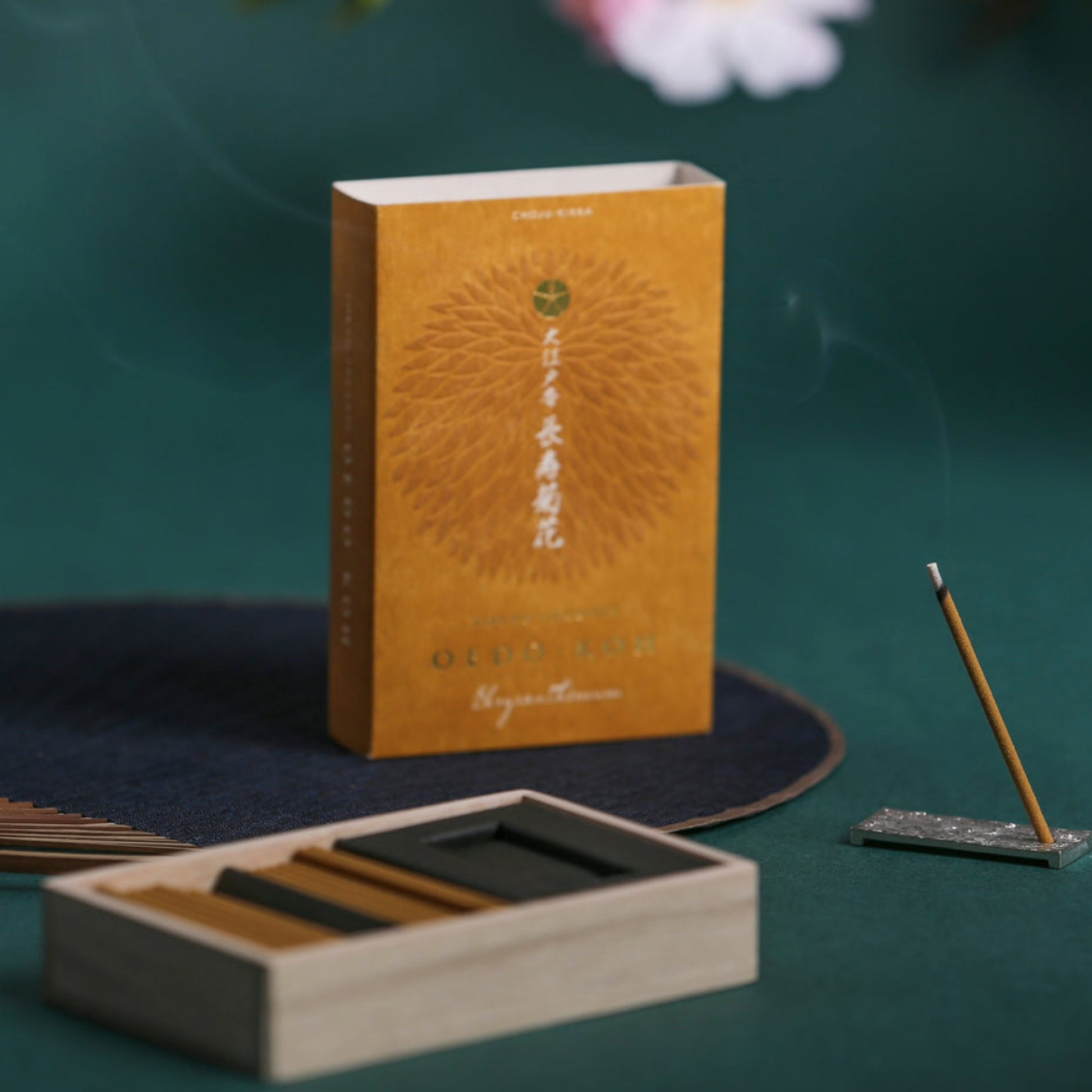 Oedo-Koh Incense Chrysanthenum on display burning on included incense stand infront of unboxed incense