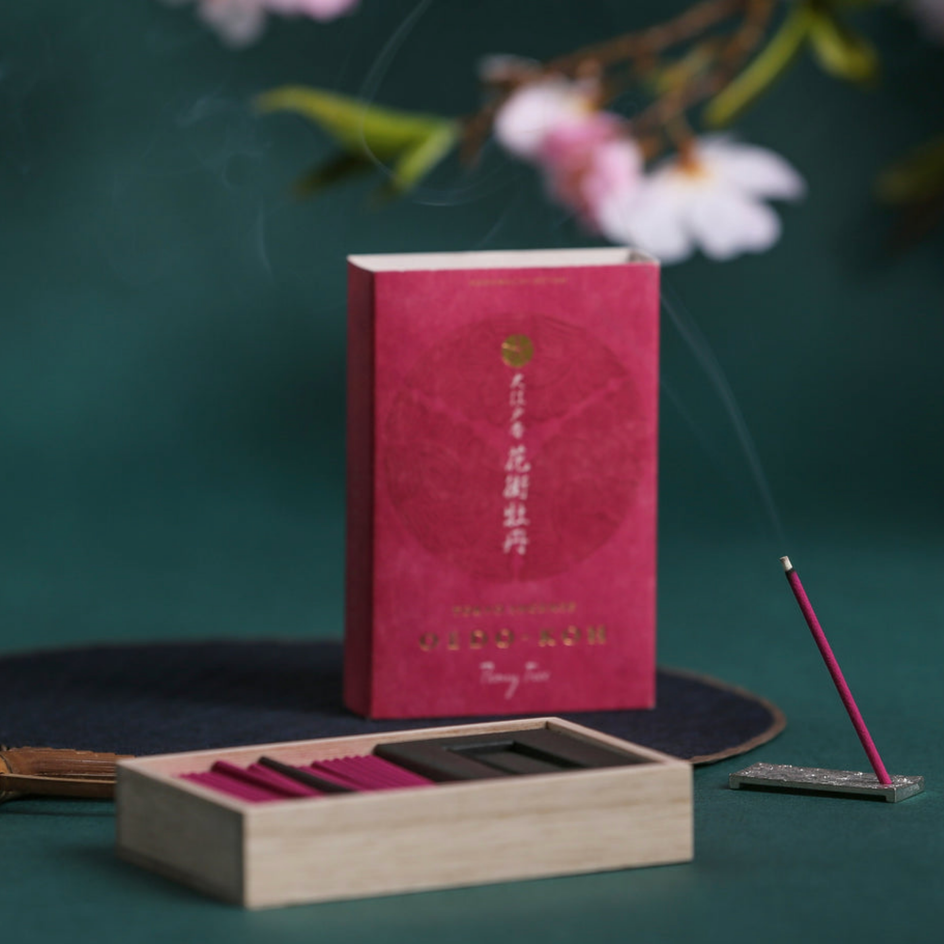 Oedo-Koh Incense Peony Tree on display burning on included incense stand infront of unboxed incense