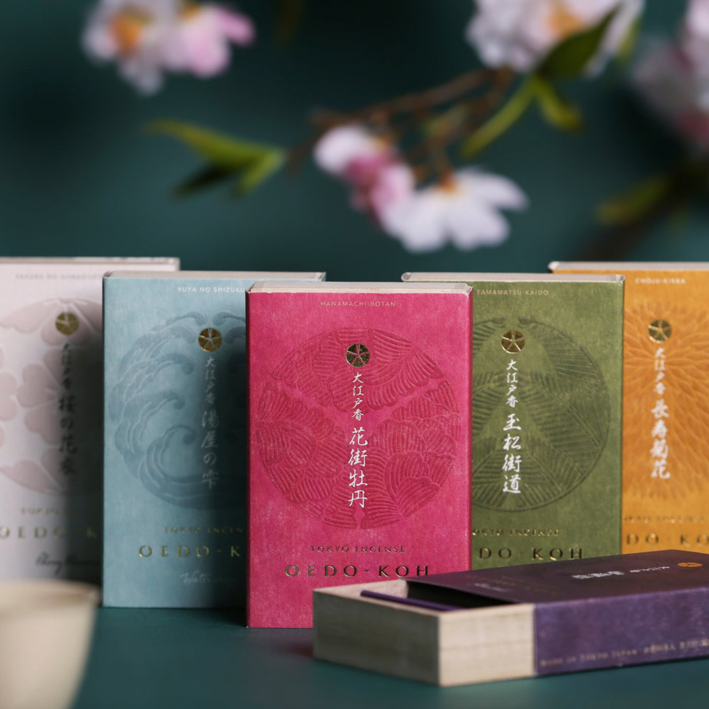 Assorted Oedo-Koh Incense infront of flowers with Oedo-Koh Incense Aloeswood half opened 