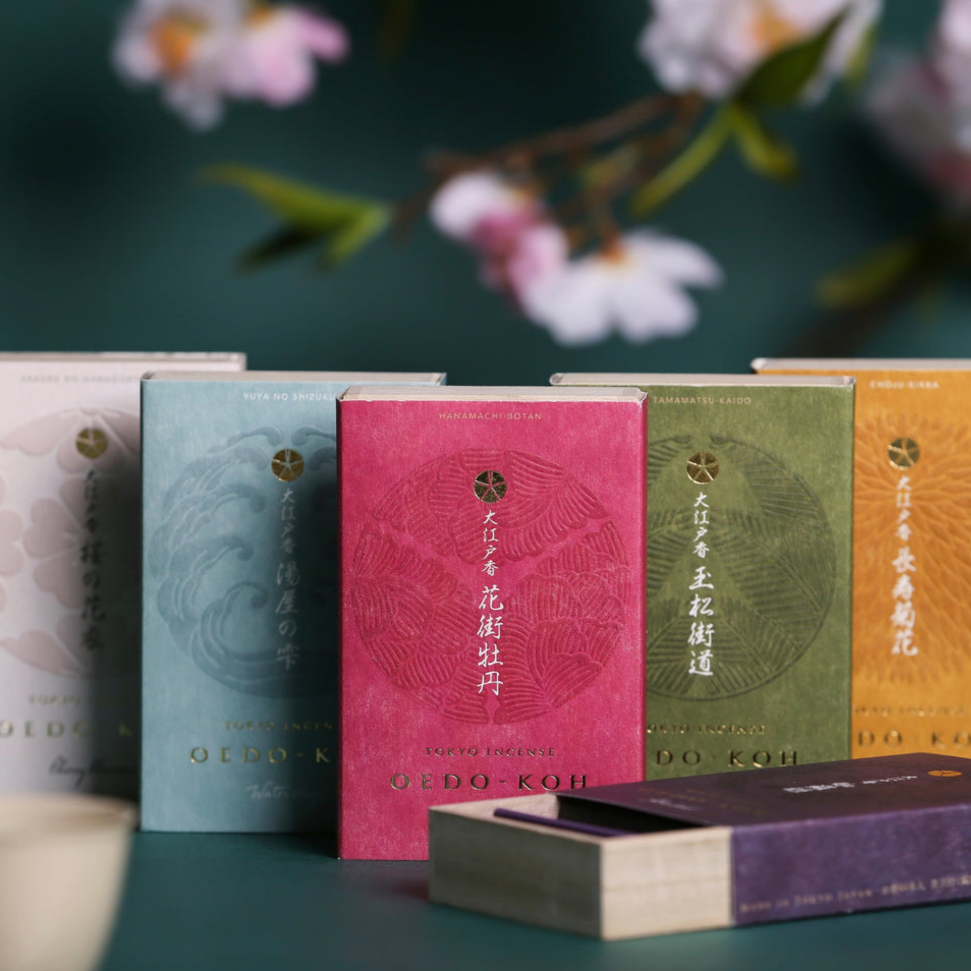 Assorted Oedo-Koh Incense infront of flowers with Oedo-Koh Incense Aloeswood half opened 