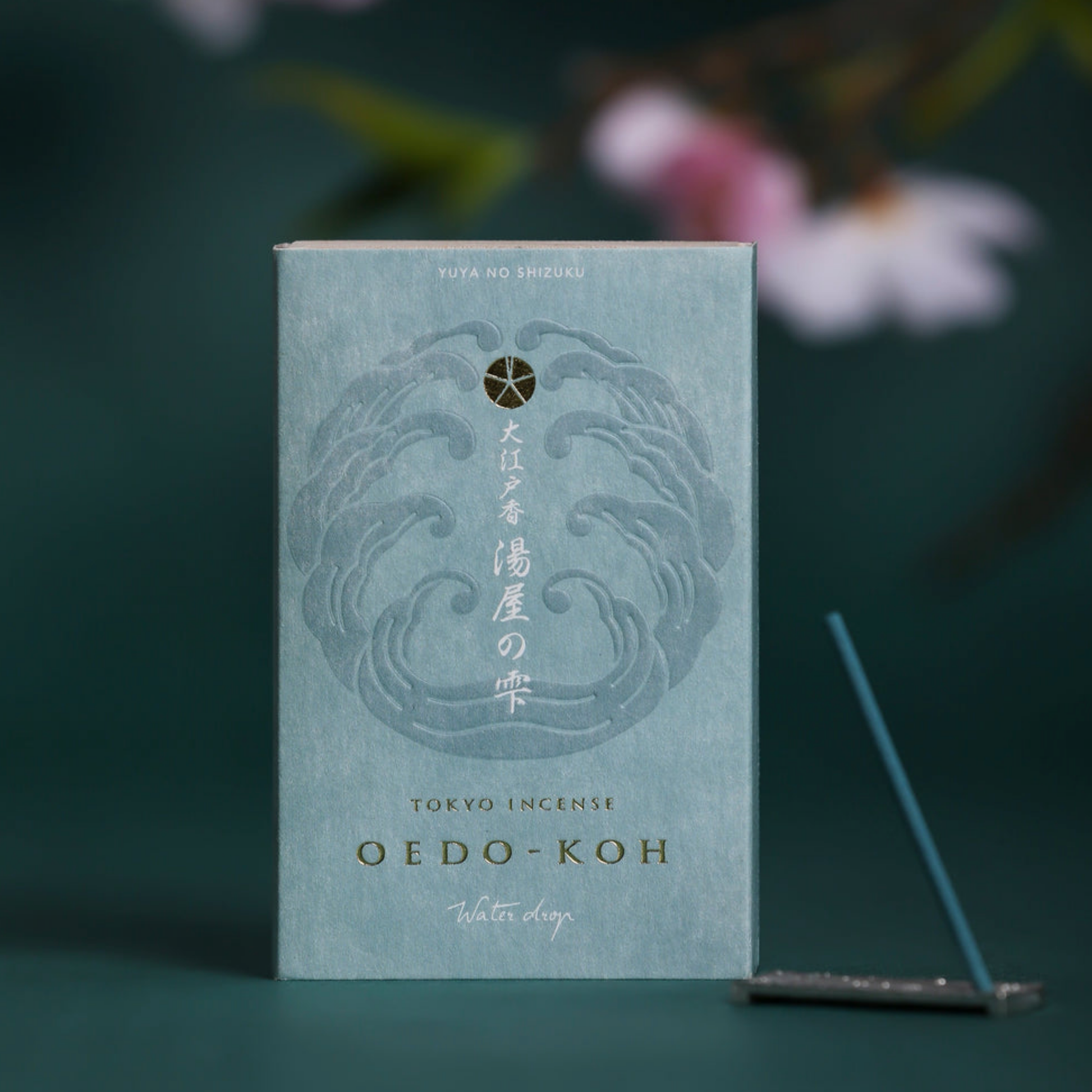 Oedo-Koh Incense Water Drop on display with incence out of packaging stood in included incense stand next to box 