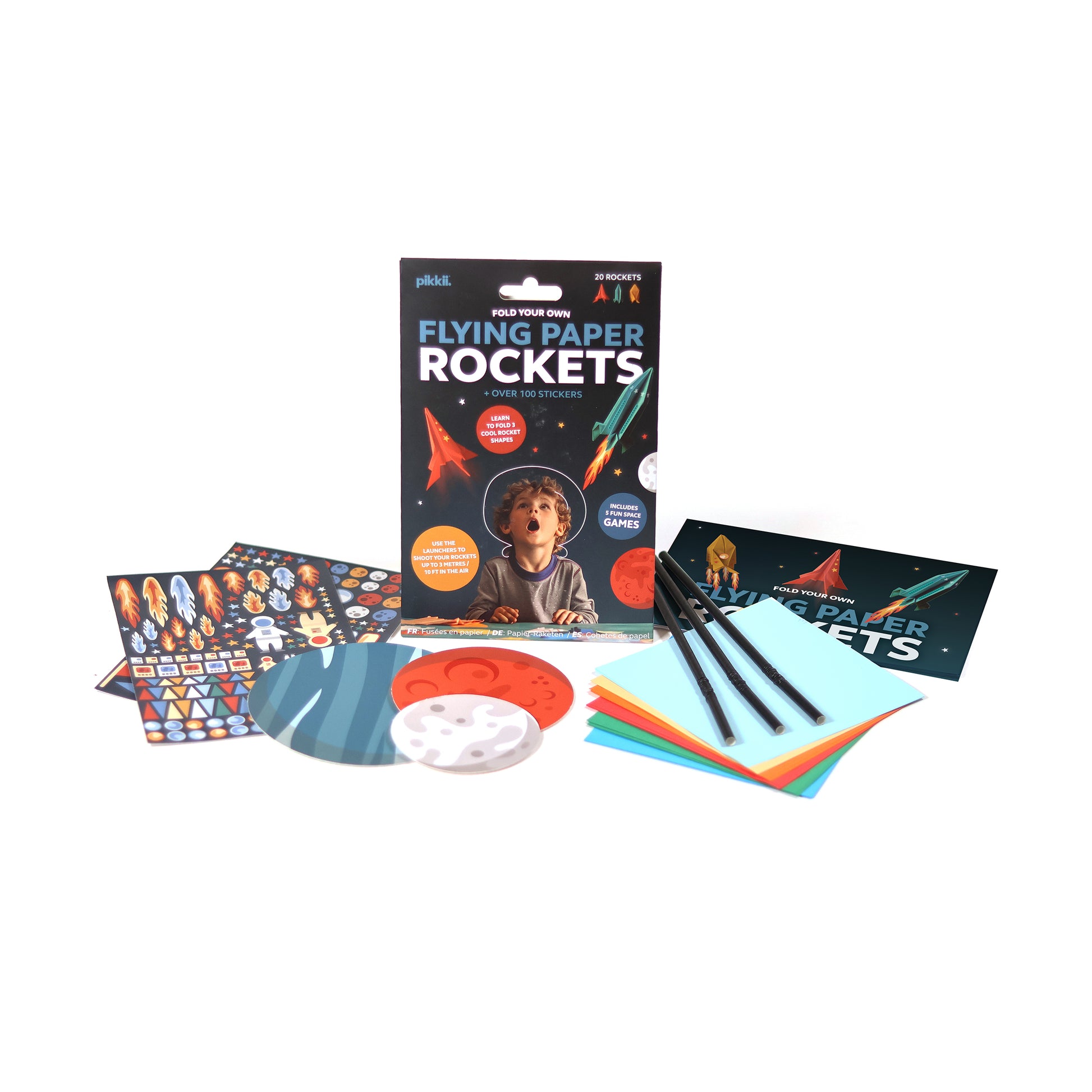 Stickers, papers and straws from Pikkii Flying Paper Rockets kit - DIY paper rocket craft set in multi-color FSC-style printed sheets, includes materials for 20 foldable rockets in 3 shapes, blow launchers, 100+ stickers, and step-by-step instructions; lightweight fun craft kit for kids ages 6+.