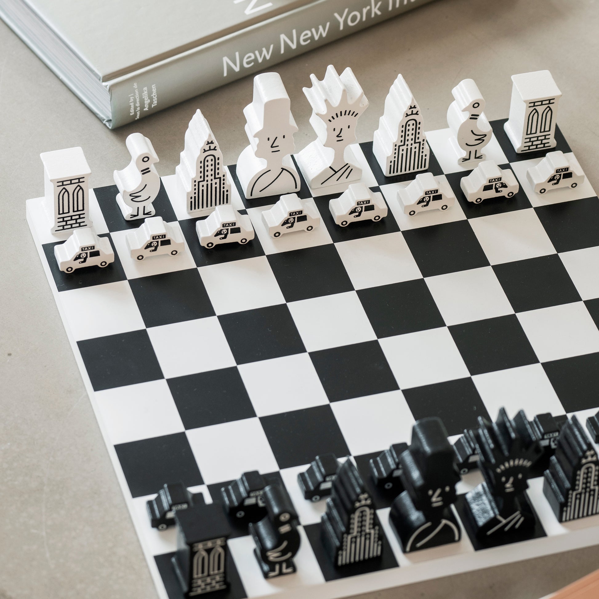 Printworks classic chess game The New Yorker Edition with wooden pieces on a table 
