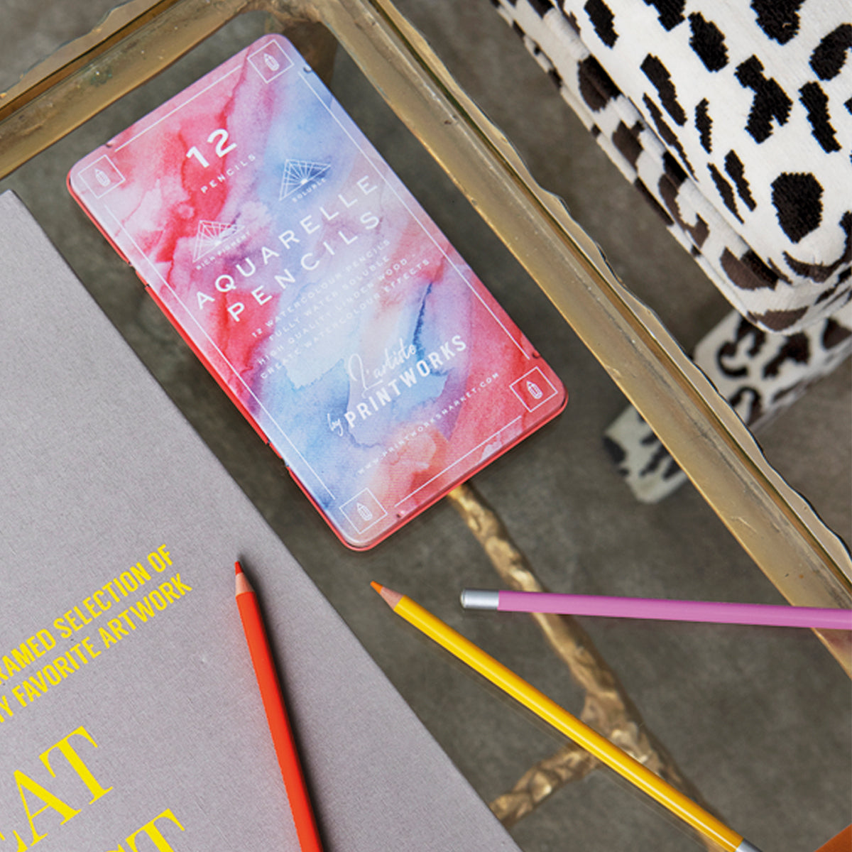 Printworks Aquarelle colour pencils set of 12 with pencils on table next to cow print bag