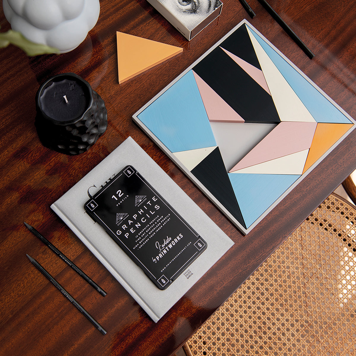 Printworks Graphite pencils set of 12 with pencils on table next archimedes puzzle and candle 