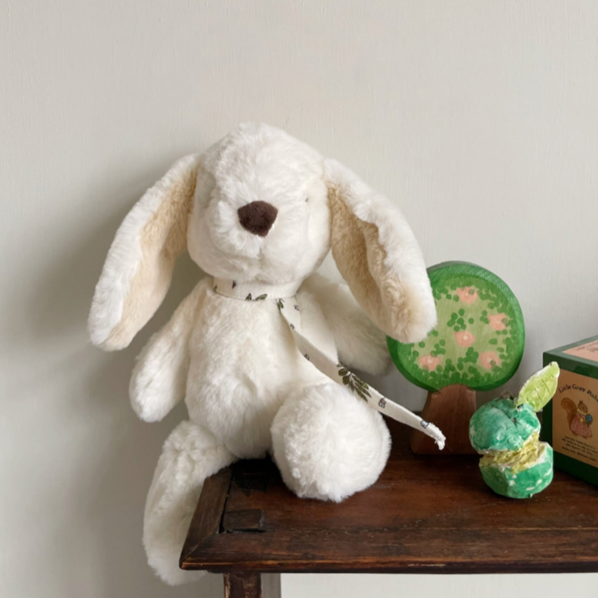 Bon Ton Toys Robert Rabbit 29cm Beige displayed on desk with toys in childs bedroom lifestyles shot