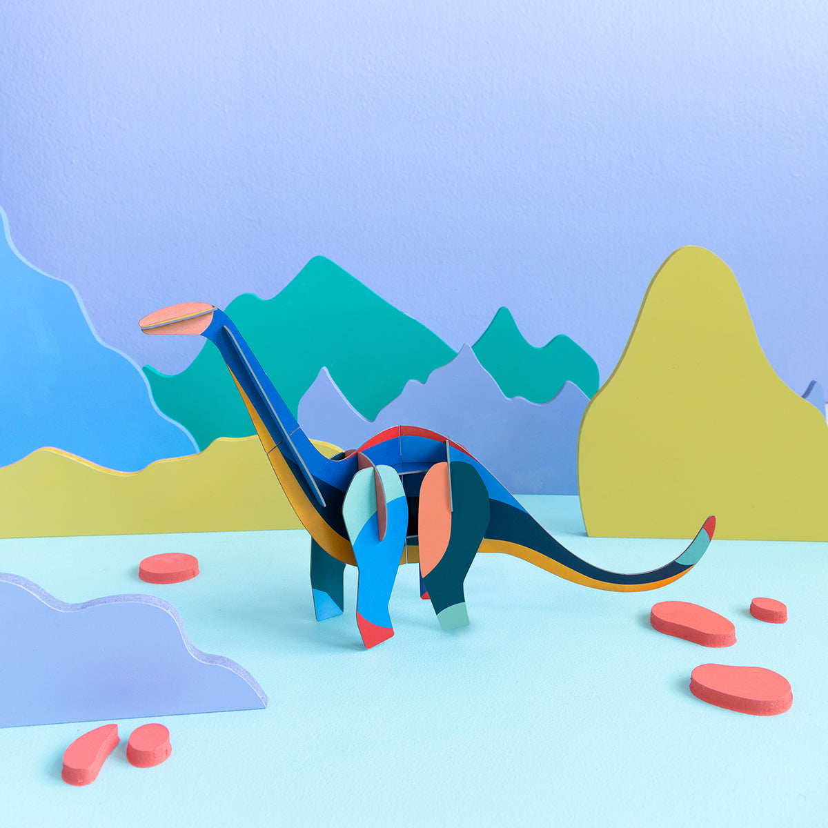 Studio Roof A4 creative play card diploducs standing on blue floor and purple background with coloured mountains 