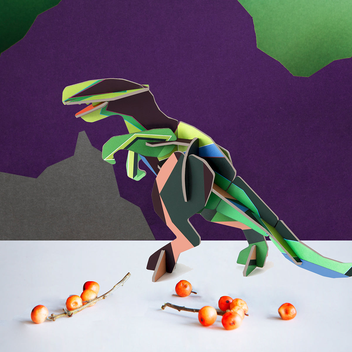 Studio Roof B6 creative play card t-rex standing on white floor with mini apples and purple background mountains 
