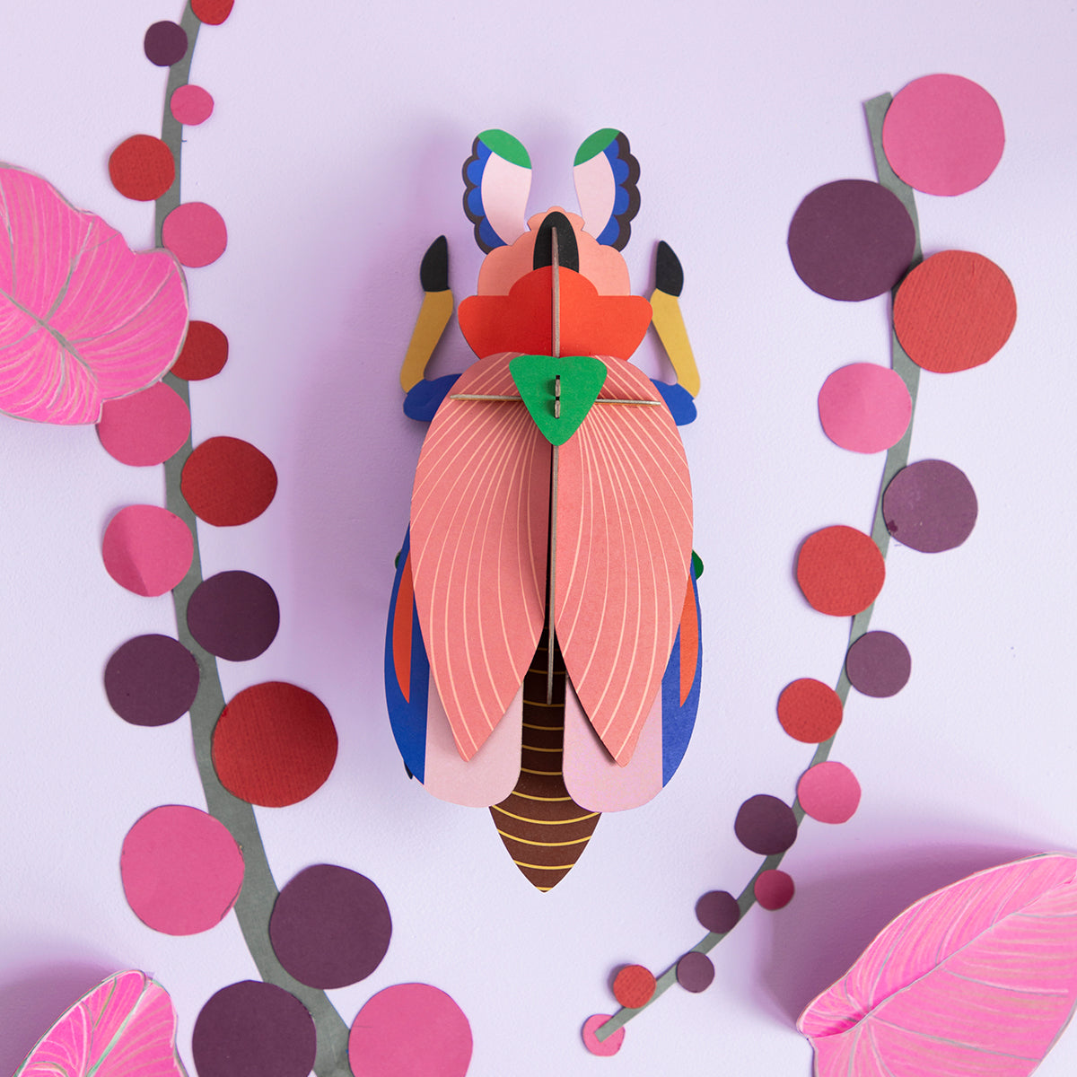Studio Roof A4 lady beetle wall art on a lilac background with colourful paper pink, red, purple dots in shape of a leaf
