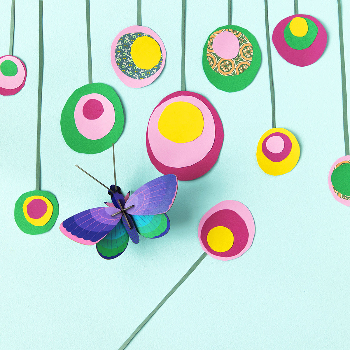 Studio Roof B7 blue copper butterfly wall art on mint wall next to multi colour dots 