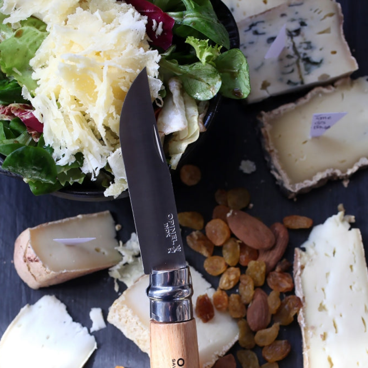 Opinel Traditional Folding Knife No12 Carbon Steel Beech on chopping board with fruit and vegatables