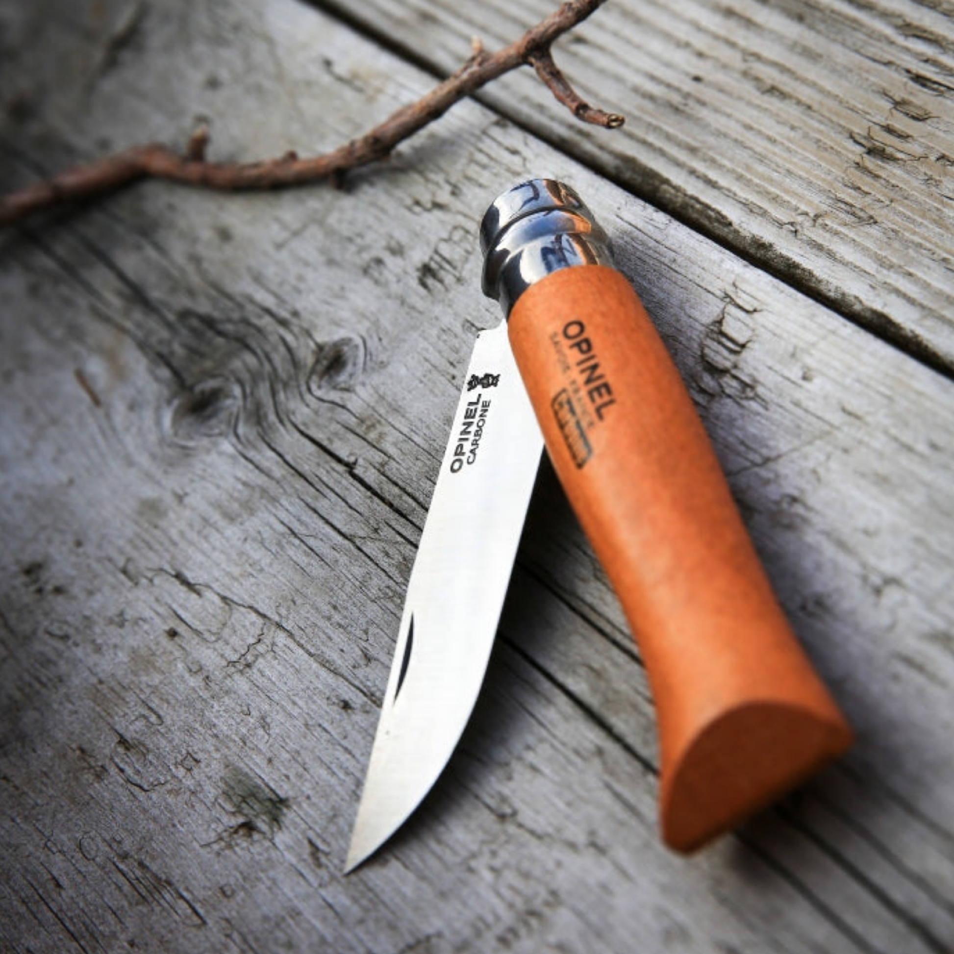Opinel Traditional Folding Knife No8 Carbon Steel Beech half folded on wooden background