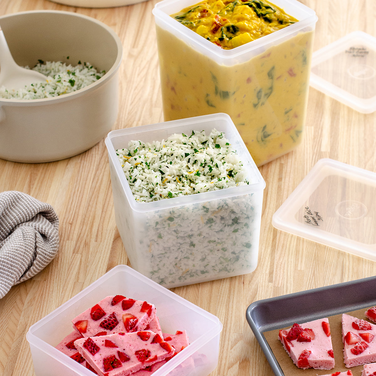 WP set of 3 freezer cubes filled with colourful food on wooden table 