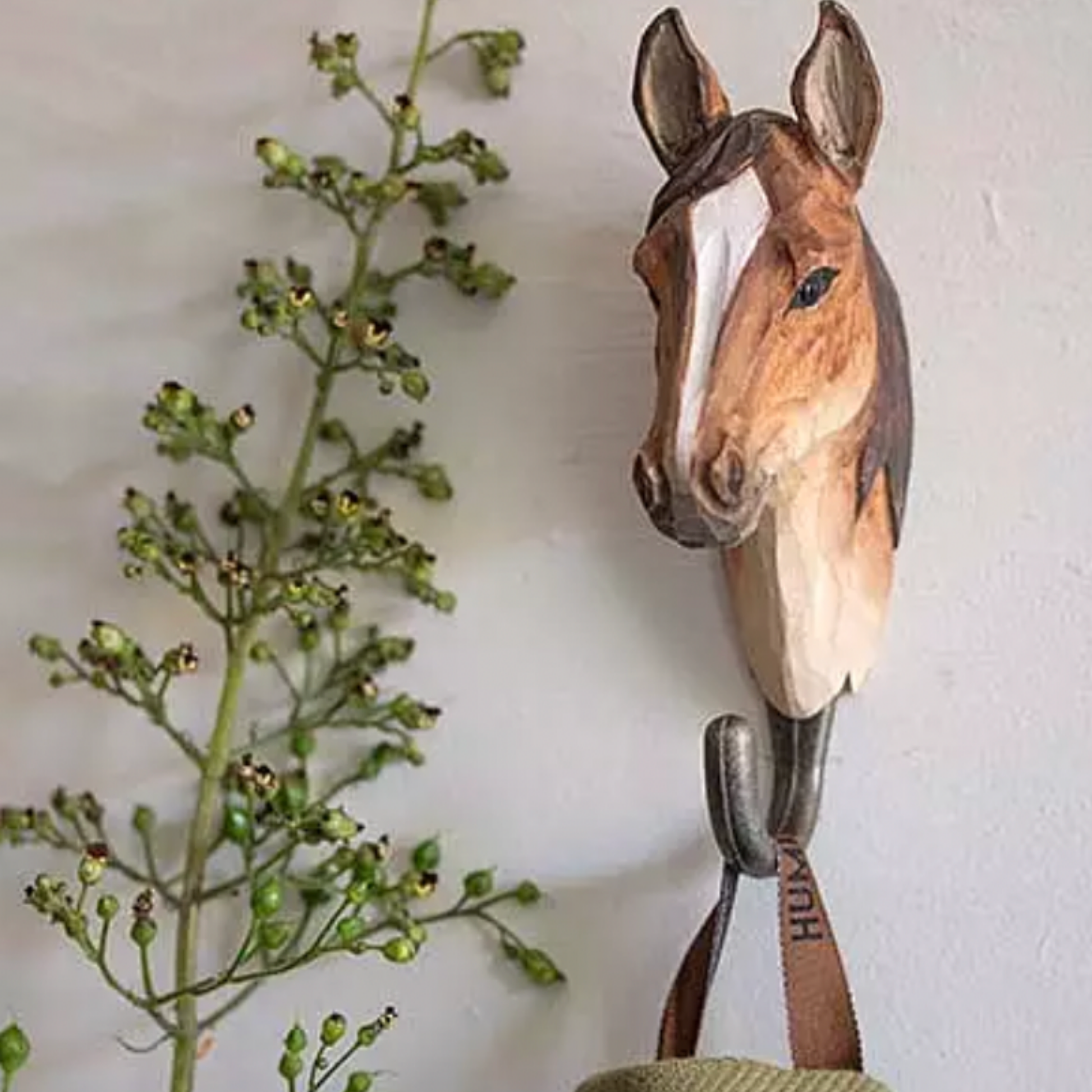 Wildlife Garden Wall Hook Horse hung on display with bag hanging from hook next to greenery