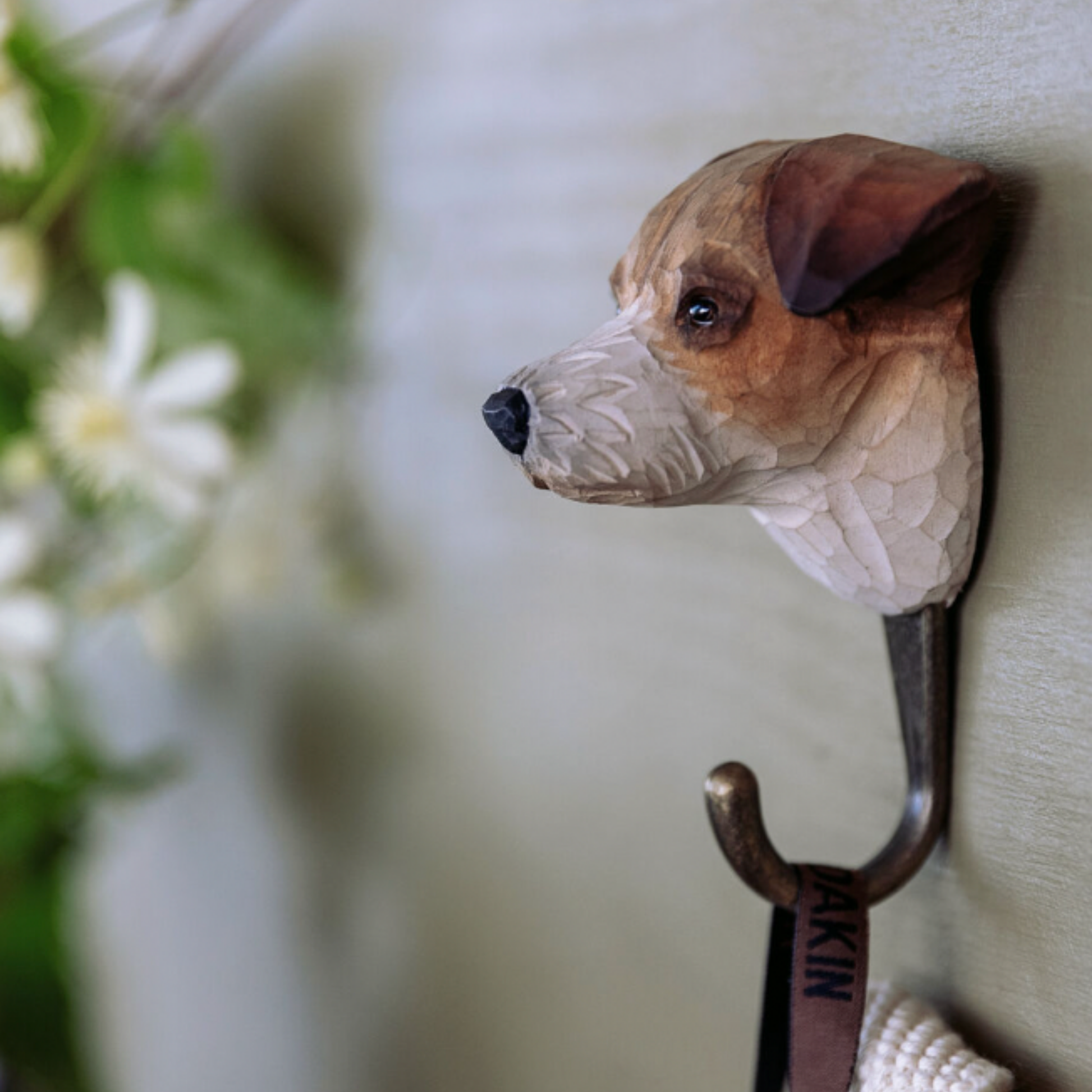Close up of Wildlife Garden Wall Hook Jack Russell on display hanging on wall with jacket on hook 