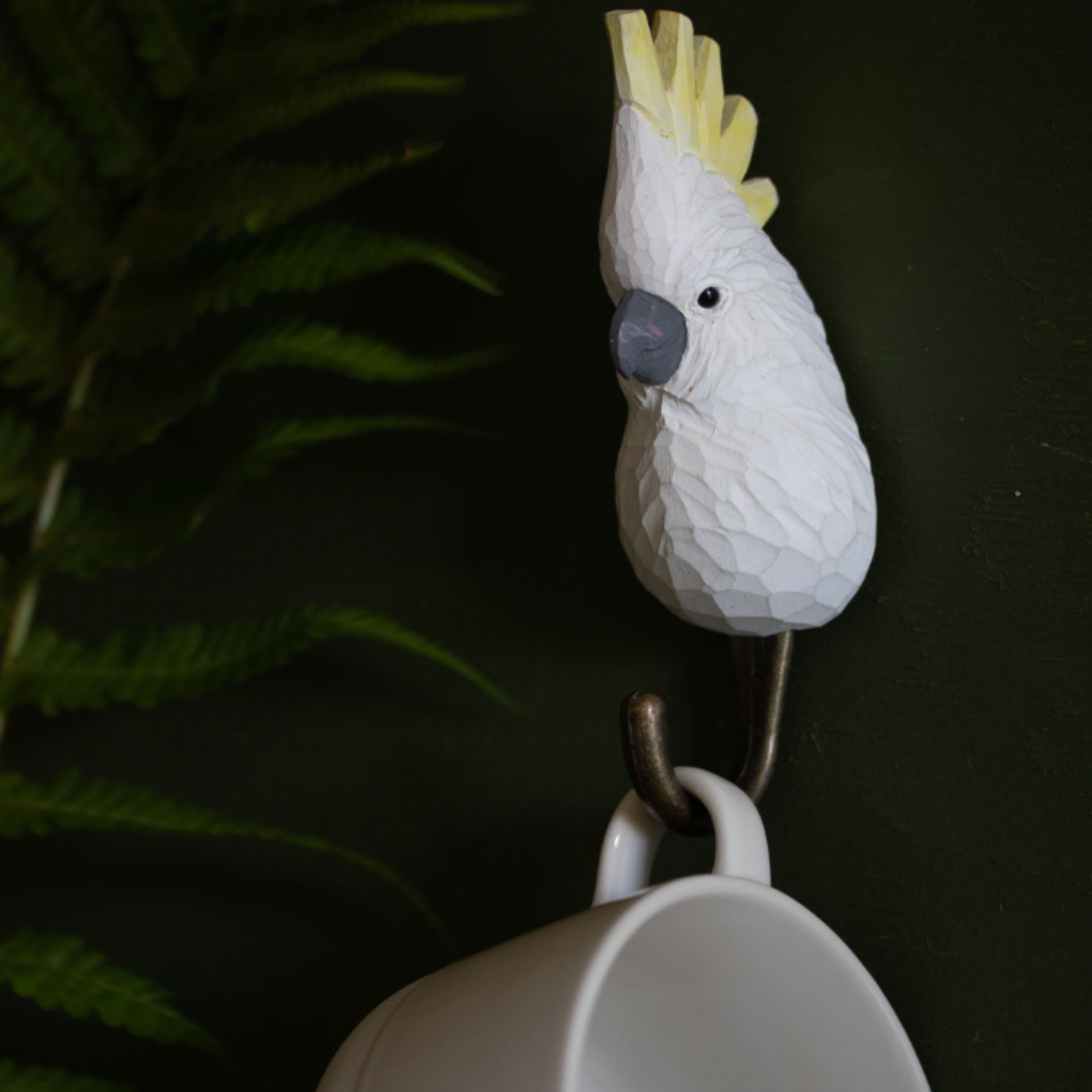 Close up of Wildlife Garden Wall Hook Sulphur Crested Cockatoo on wall holding mug on hook