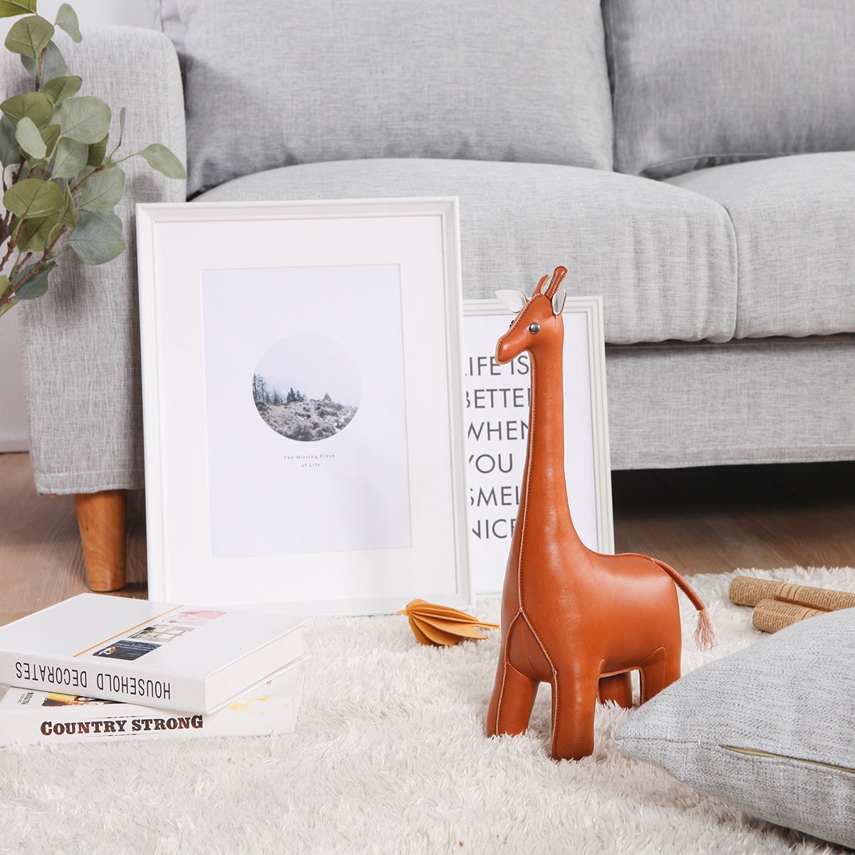 Doorstop sized Classic Giraffe Tan by Zuny shown sitting on a shagpile rug.