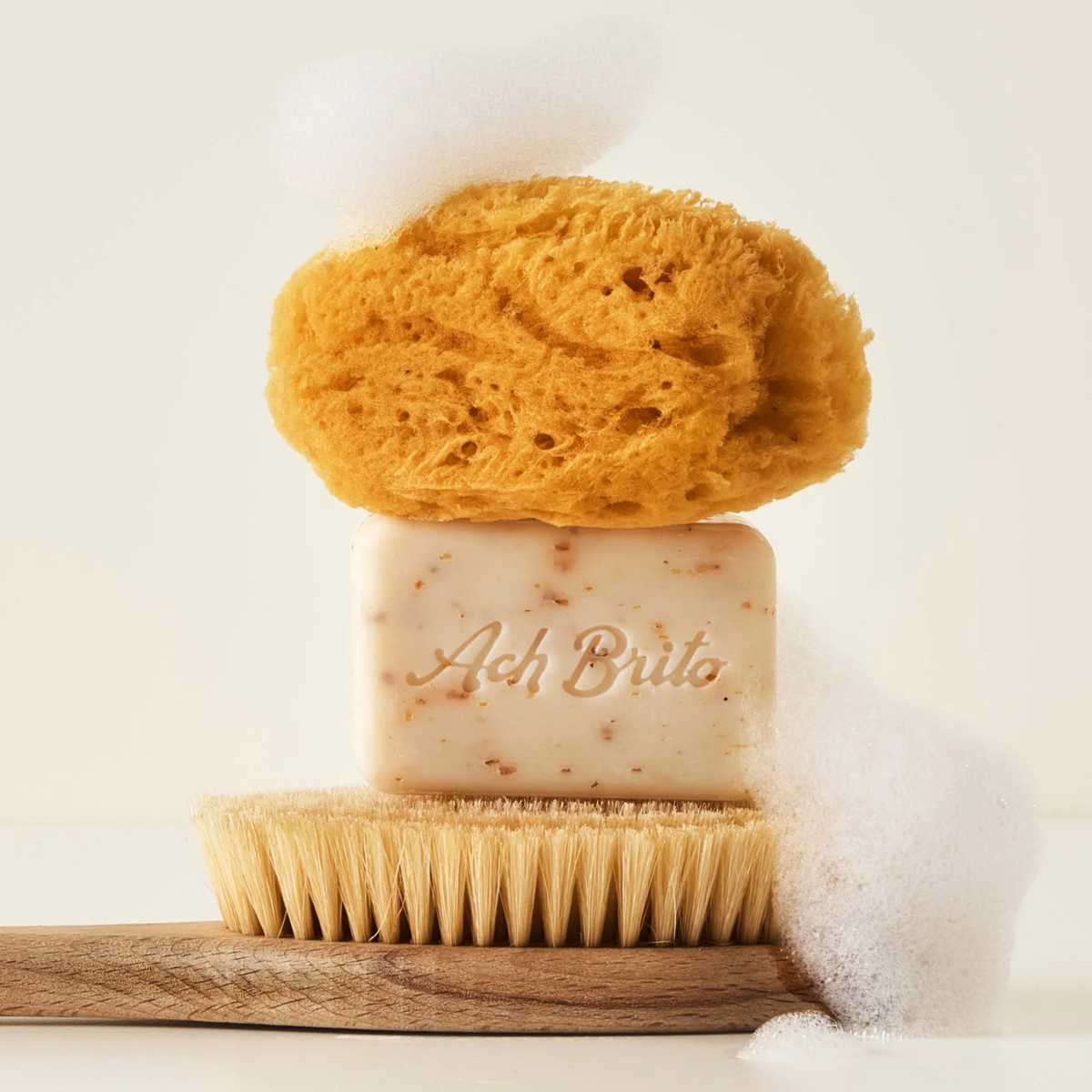 Brush and sponge with Ach Brito SPA Exfoliating Soap Algae & Seasalt that is made with vegetable soap base, red algae that exfoliate the skin with light scent.