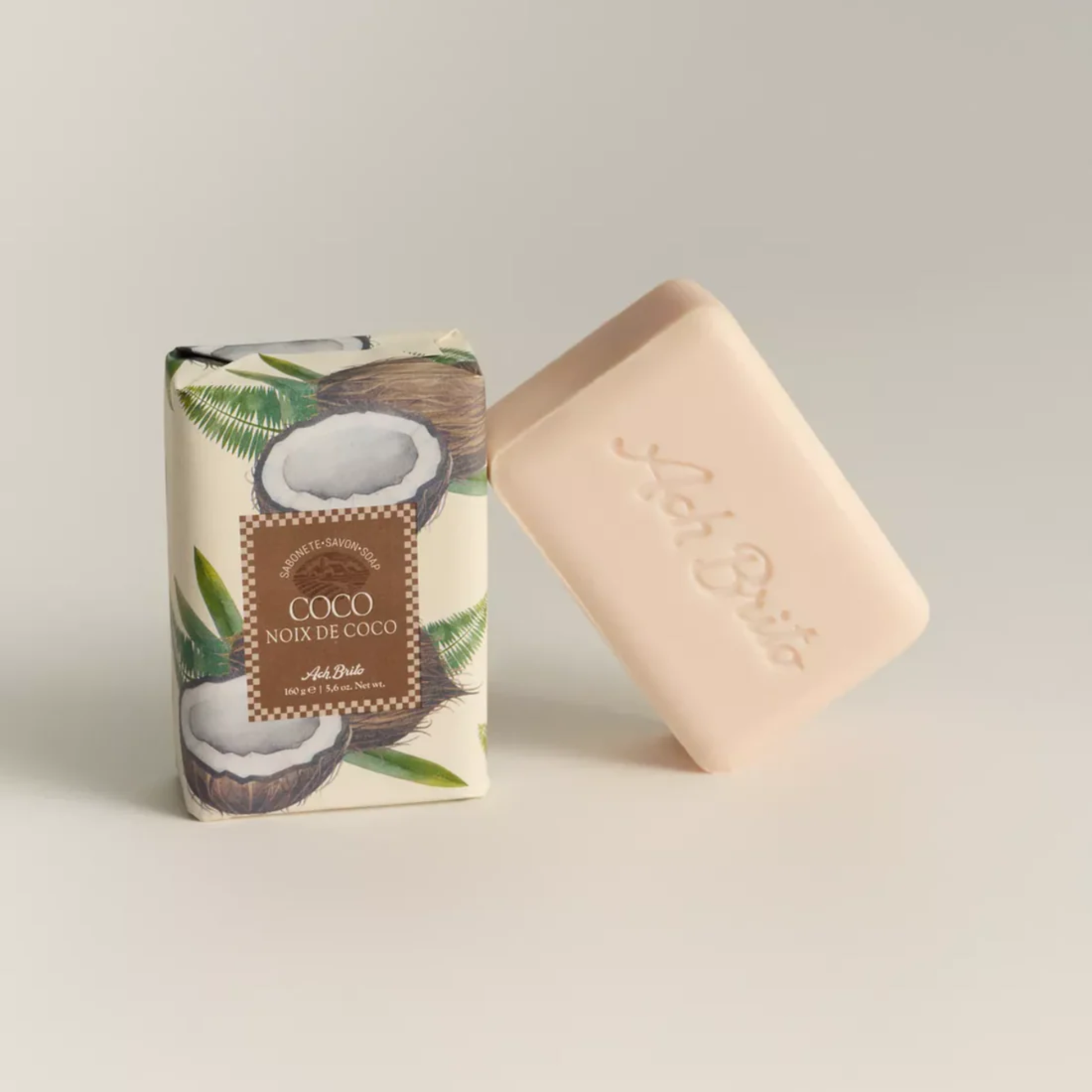 Soap and packaging view from Ach. Brito Vegetable Soap 160g, coconut-scented white bar made with a vegetable base, produces creamy lather, eco-friendly, suitable for daily bath or kitchen hand hygiene.