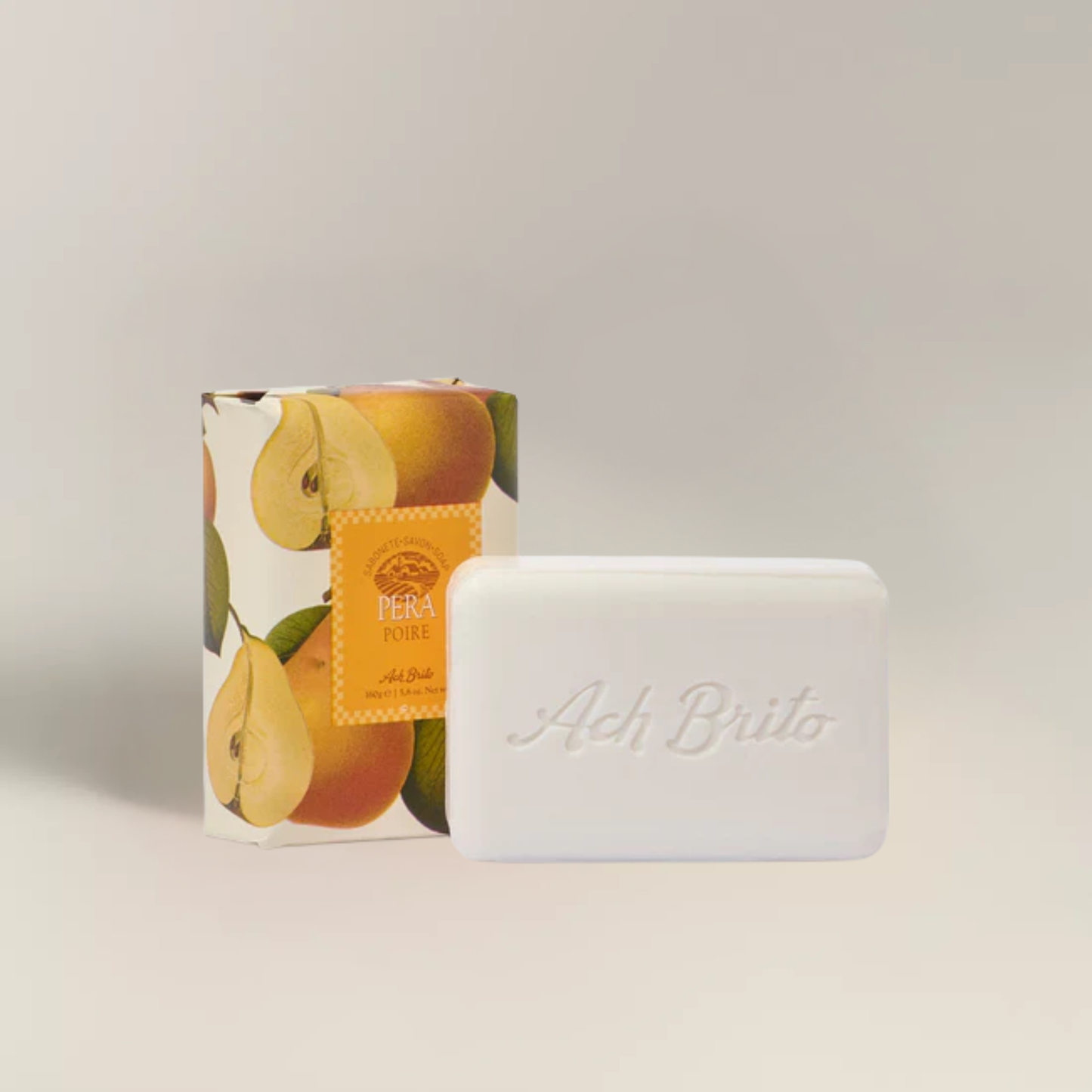 Packaging and soap view from Ach. Brito Vegetable Soap 160g, light cream pear-scented bar made with a vegetable base, produces creamy lather, eco-friendly, ideal for daily bath or kitchen hand hygiene.