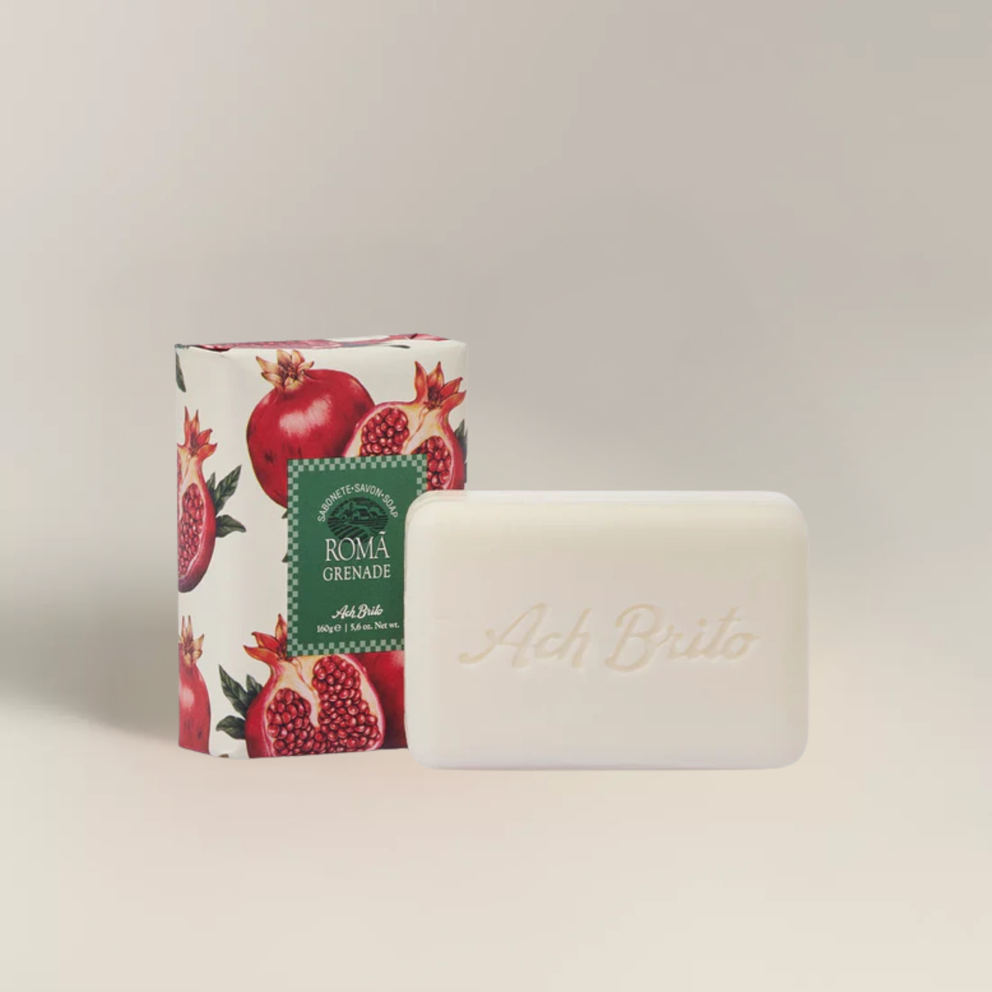 Packaging and soap view for Ach. Brito Vegetable Soap 160g, soft pink pomegranate-scented bar made with a vegetable base and sweet almond oil, produces creamy lather, eco-friendly, perfect for daily bath or kitchen hand washing.