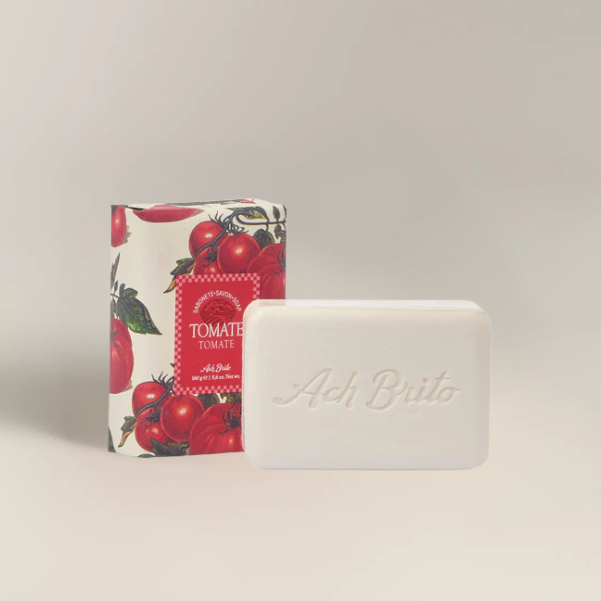 Soap and packaging view of Ach. Brito Vegetable Soap 160g, soft red tomato-scented bar made with a vegetable base, creamy and abundant lather, eco-friendly, perfect for daily bath or kitchen hand washing.