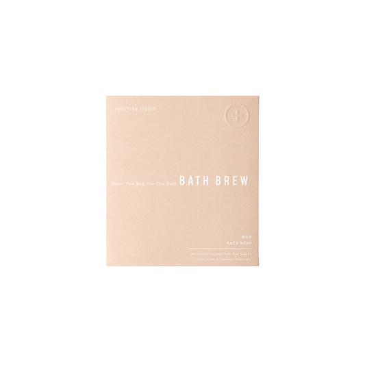 Packaging of the Addition Studio Bath Brew Milk 75g with Epsom salt for relaxation, goats milk, raw organic cocoa butter and lavender scent.