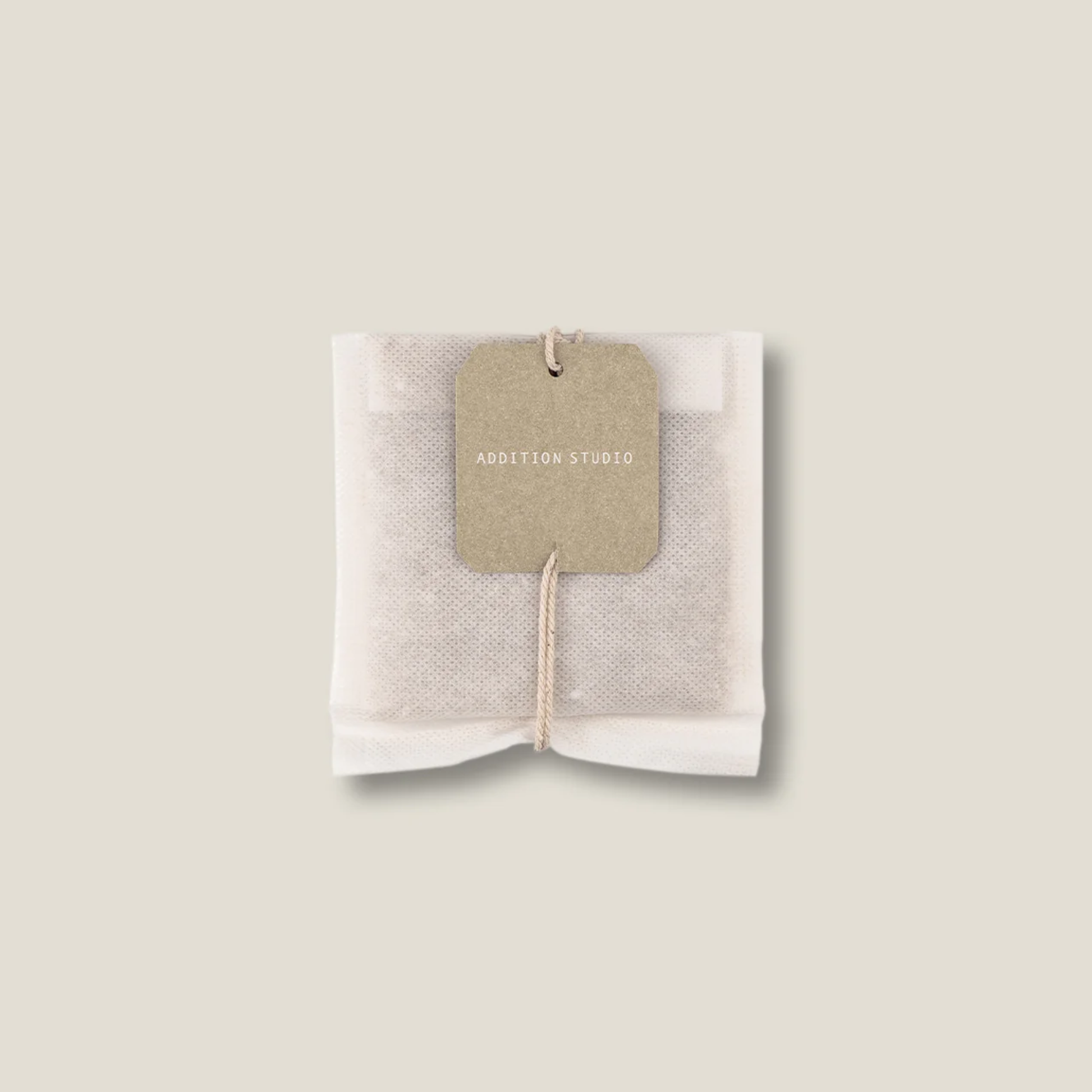 Upclose view of the tea bath bag of the Addition Studio Bath Brew Milk 75g with Epsom salt for relaxation, goats milk, raw organic cocoa butter and lavender scent.