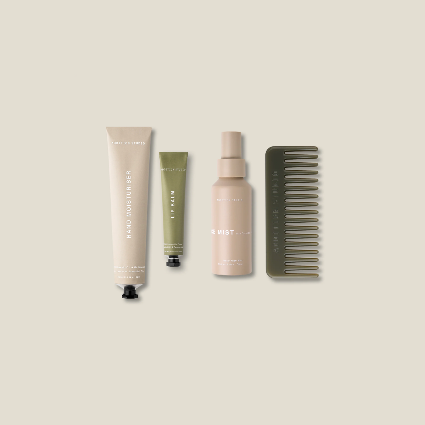 Four items from the Addition Studio Refresh Travel Gift Set which includes a cedar and lavender hand cream ,lip balm, face mist and comb.