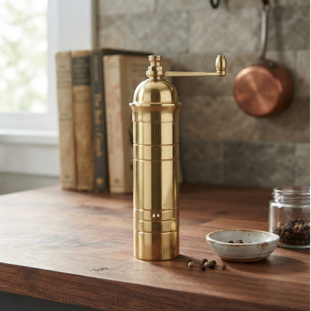 Alexander Mills Brass Pepper Grinder 17cm seen on the table, it has 100% metal mechanism with 3DCut system for fine or course grinding.