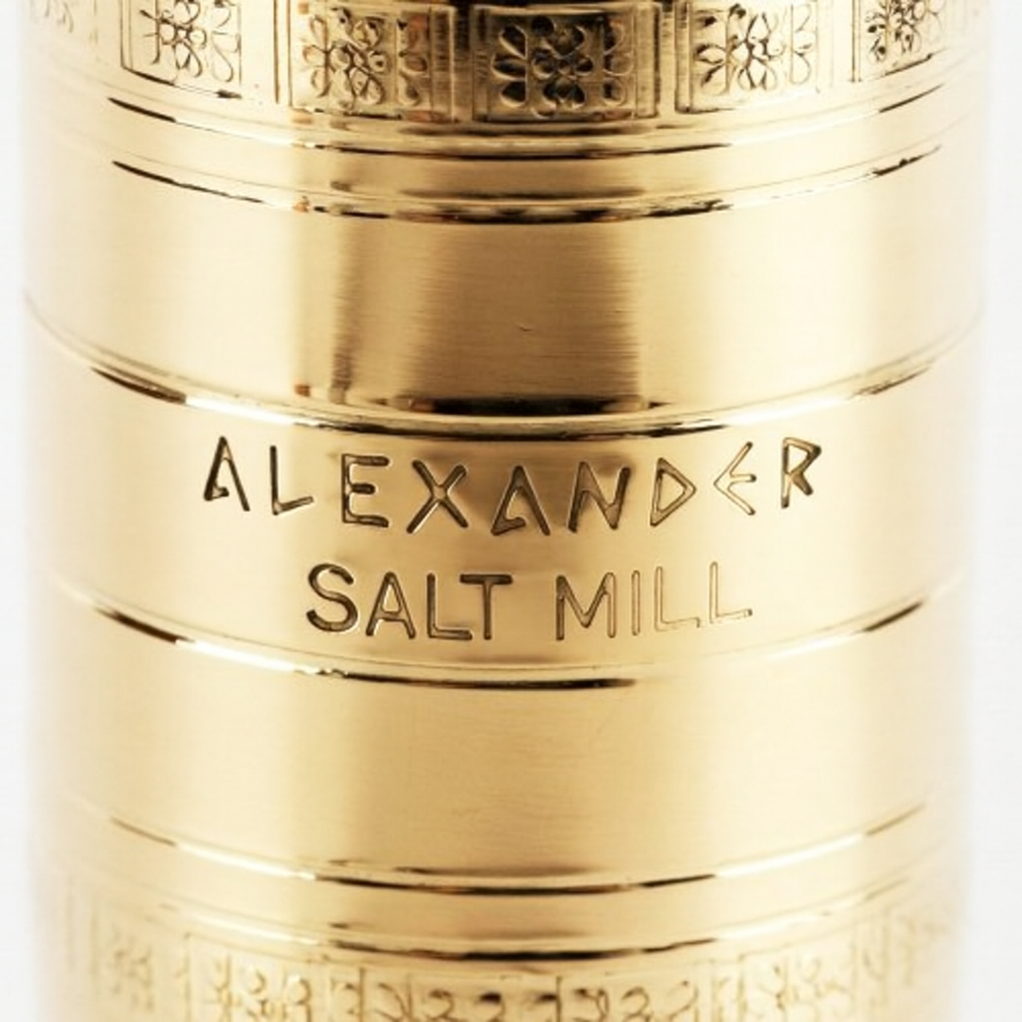 Closeup of Alexander Mills salt grinder showing engraving and pattern on the brass body.