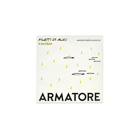 Front cover of the packaging of the Armatore Anchovy Fillets in Olive Oil 90g, handpicked and hand-processed that matured for a long time in salt and pure olive oil.