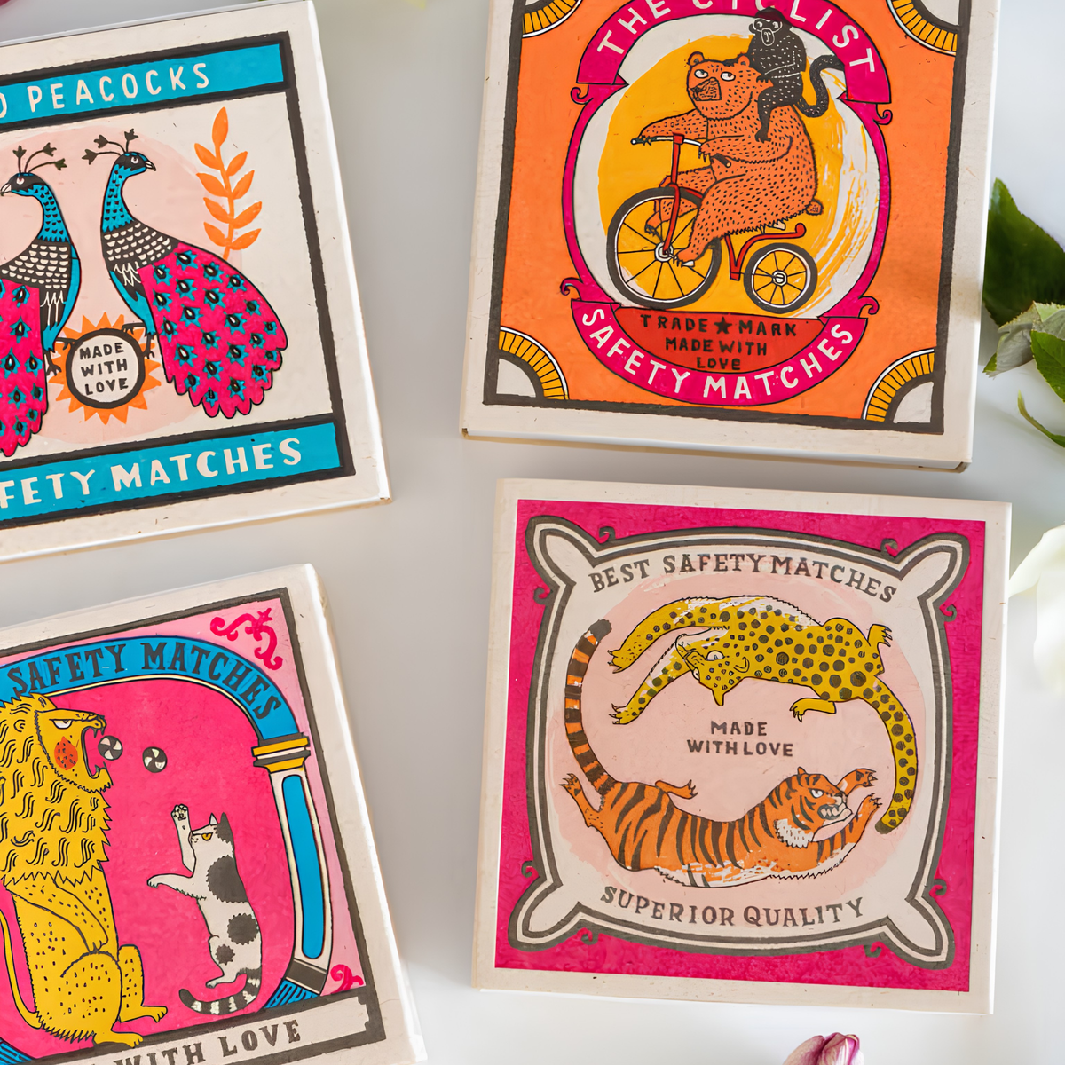 Showing other match designs with the Archivist Luxury Matches Chasing Big Cats in multicolour, FSC Mix certified paper matchbox with cheetah and tiger illustrations, containing 125 natural wooden matches with white tips.