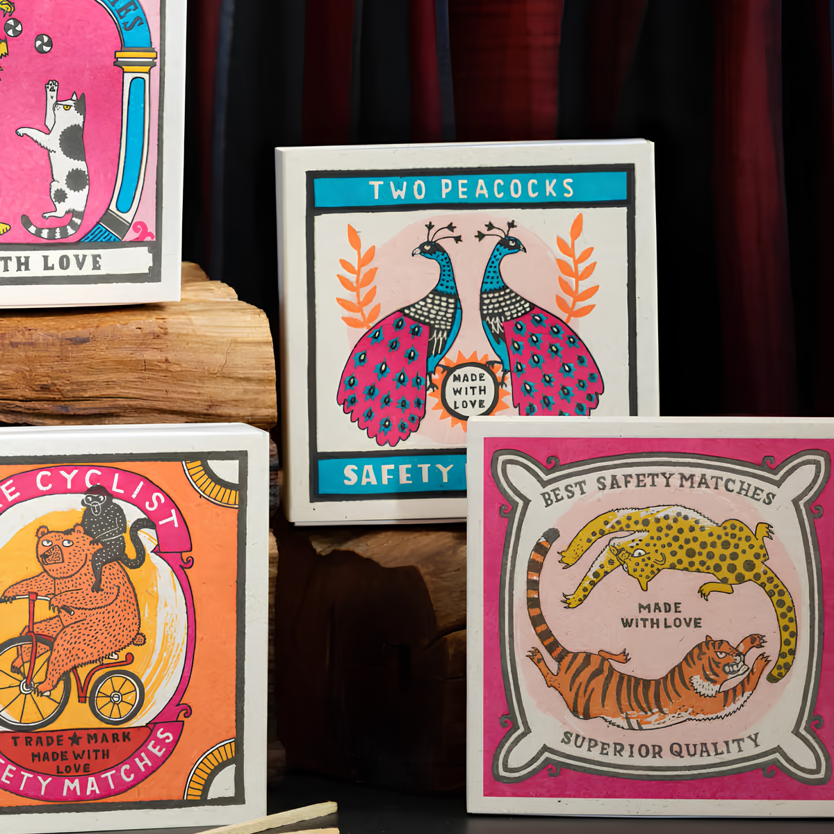Showing other match designs with the Archivist Luxury Matches Chasing Big Cats in multicolour, FSC Mix certified paper matchbox with cheetah and tiger illustrations, containing 125 natural wooden matches with white tips.
