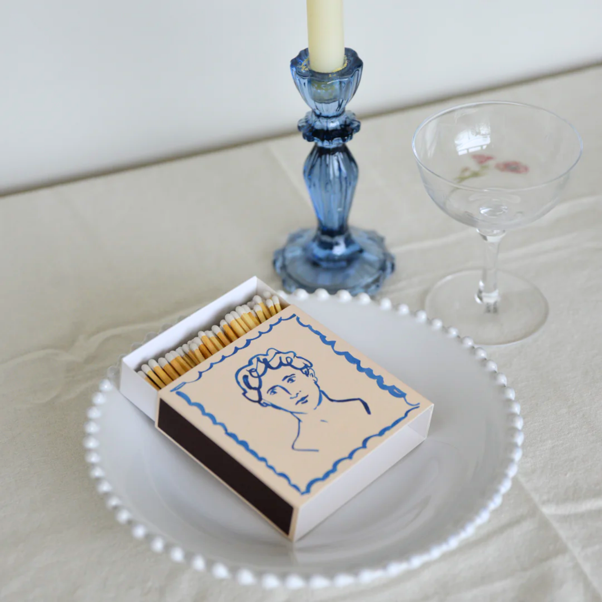 Luxury matches handsome on display in table with table cloth and candle stick