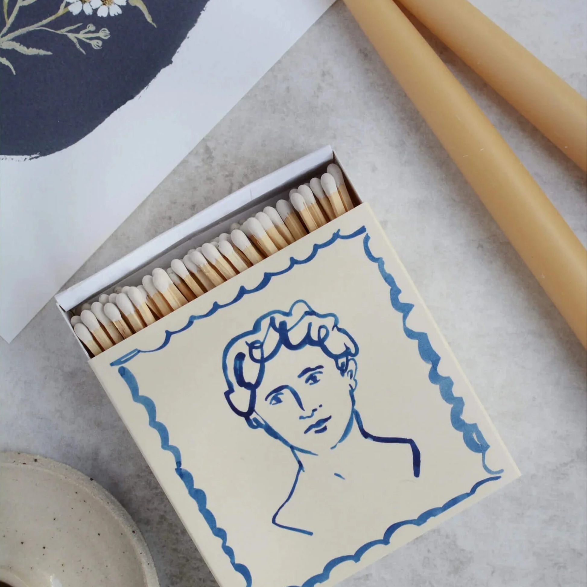 Luxury matches handsome on display on marble table and candle stick