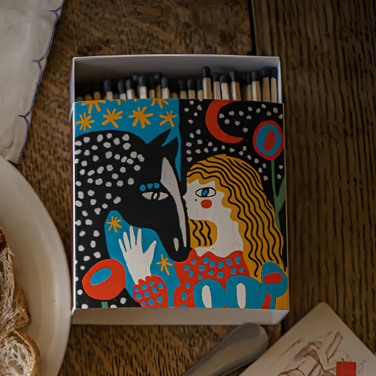 Shown on the table, Archivist Luxury Matches Heart Horse in blue with a starry sky, FSC Mix certified paper matchbox featuring a girl and horse illustration, with 125 natural wooden matches and black tips.