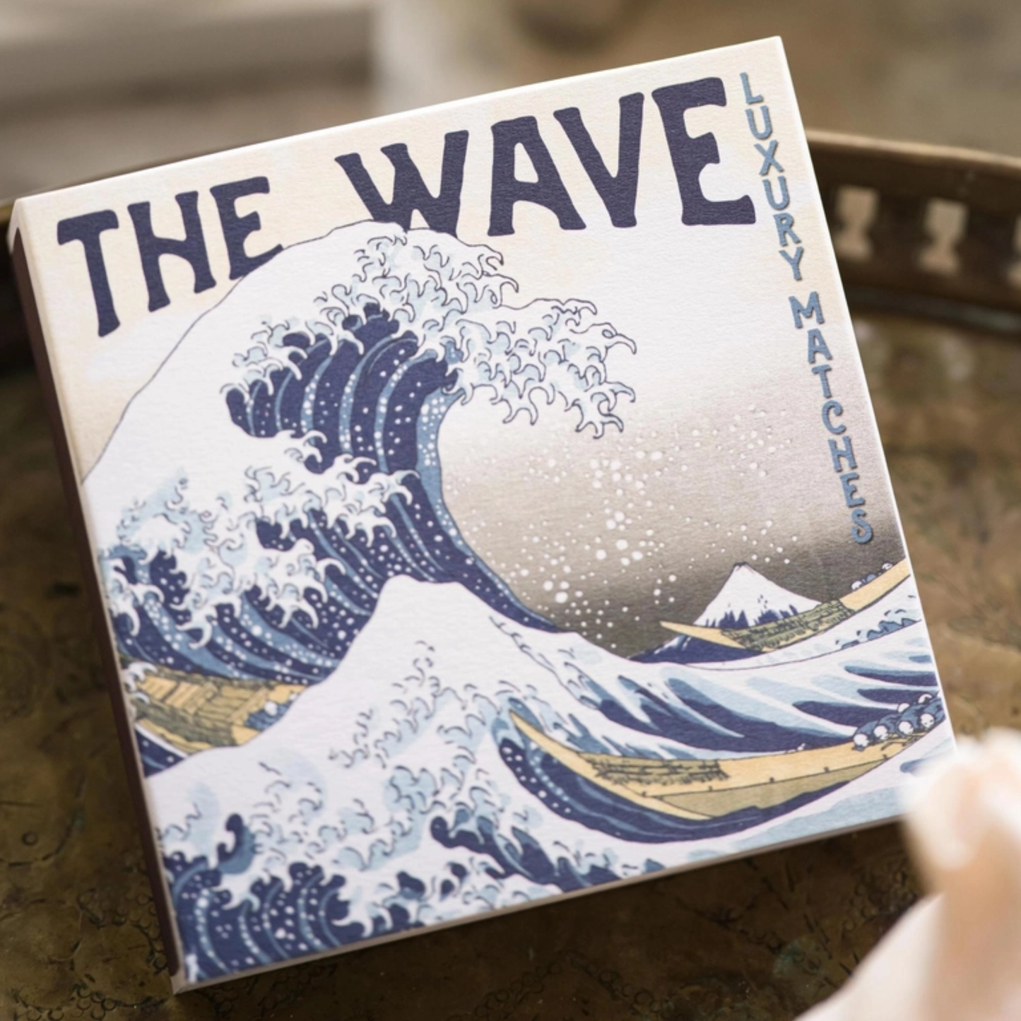 Upclose front view in a tray of Archivist Hokusai Wave Matches - Square Matchbox with The Great Wave Art Design - 125 Natural White-Tipped Matches - FSC Wood, UK Litho Printed, Eco-Friendly Decorative Match Set