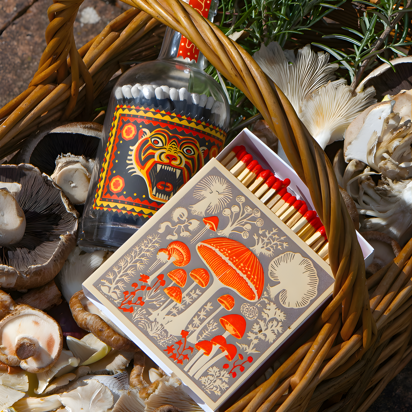 Shown in a basket, the Archivist Luxury Matches Mushroom which features a selection of wild mushrooms in neutral tones with red accents. Contains 125 matches (100 mm, red tips, white tray), letterpress printed in the UK with FSC-certified wood and wrapped in compostable cello-ideal for coffee tables, mantelpieces, or gifting.