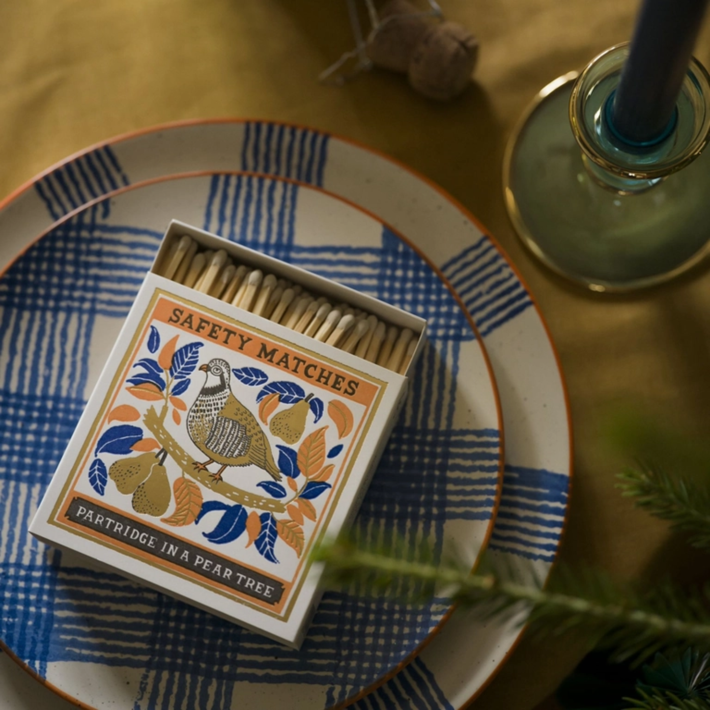 Shown on a plate open with white tipped matches Archivist Partridge in a Pear Tree Matches - Square Matchbox with Partridge and Pear Tree Design - Natural White-Tipped Matches - FSC Wood Material, UK Letterpress Print, Eco-Friendly Decorative Match Set